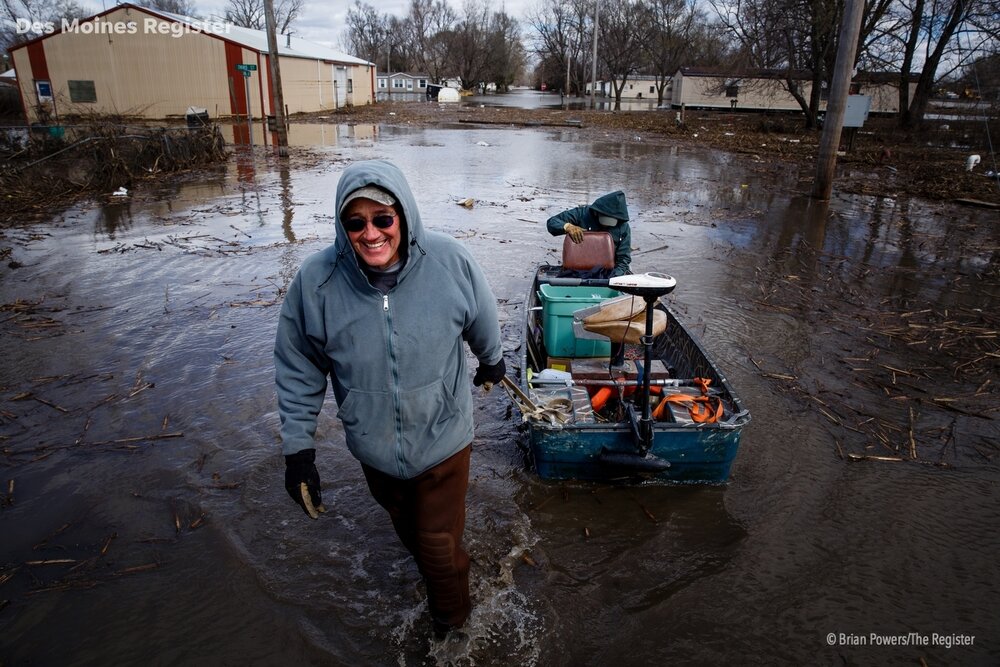  After cleaning and replacing the breakers and fuses in the third of his three pumps Mayor Andy Young pulls electrician Ben Lundstrom back to Main street in his fishing boat on Friday, April 12, 2019, in Pacific Junction. The levee's meant to protect