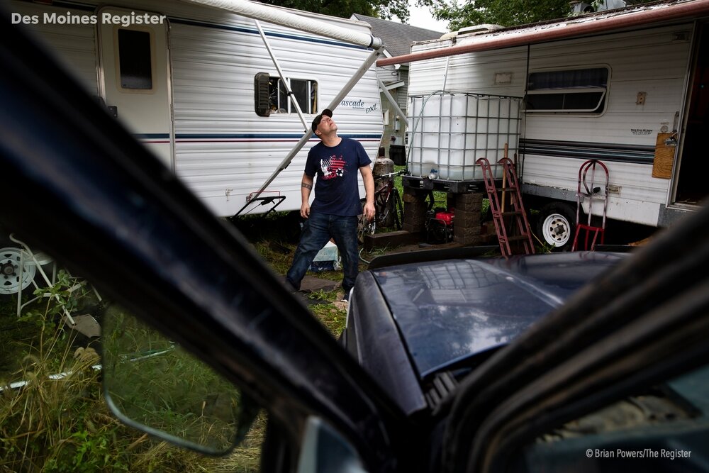  Matt Tyson, 39 of Pacific Junction, looks up at the sky as rain begins to fall outside his trailer on Wednesday, Oct. 2, 2019 in Pacific Junction. Tyson grew up in Pacific Junction and lost his home as well as family members homes in the spring floo
