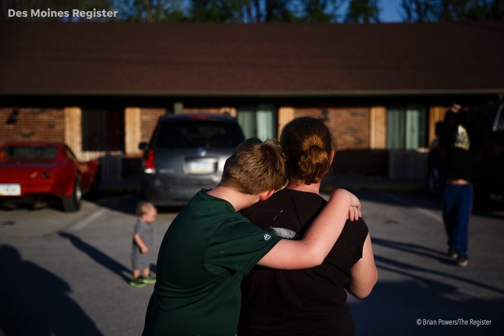  TJ Schmitt, 10 hugs his mother Jess Schmitt in the parking lot of Hotel Arthur where their family of six has been living since their home flooded earlier this month on Wednesday, April 24, 2019, in Glenwood.  