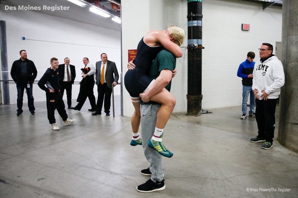  Beau Lombardi hugs his brother Rocky after winning the class 3A 220 pound match at the Iowa state wrestling championships on Saturday, Feb. 16, 2019 in Des Moines.  