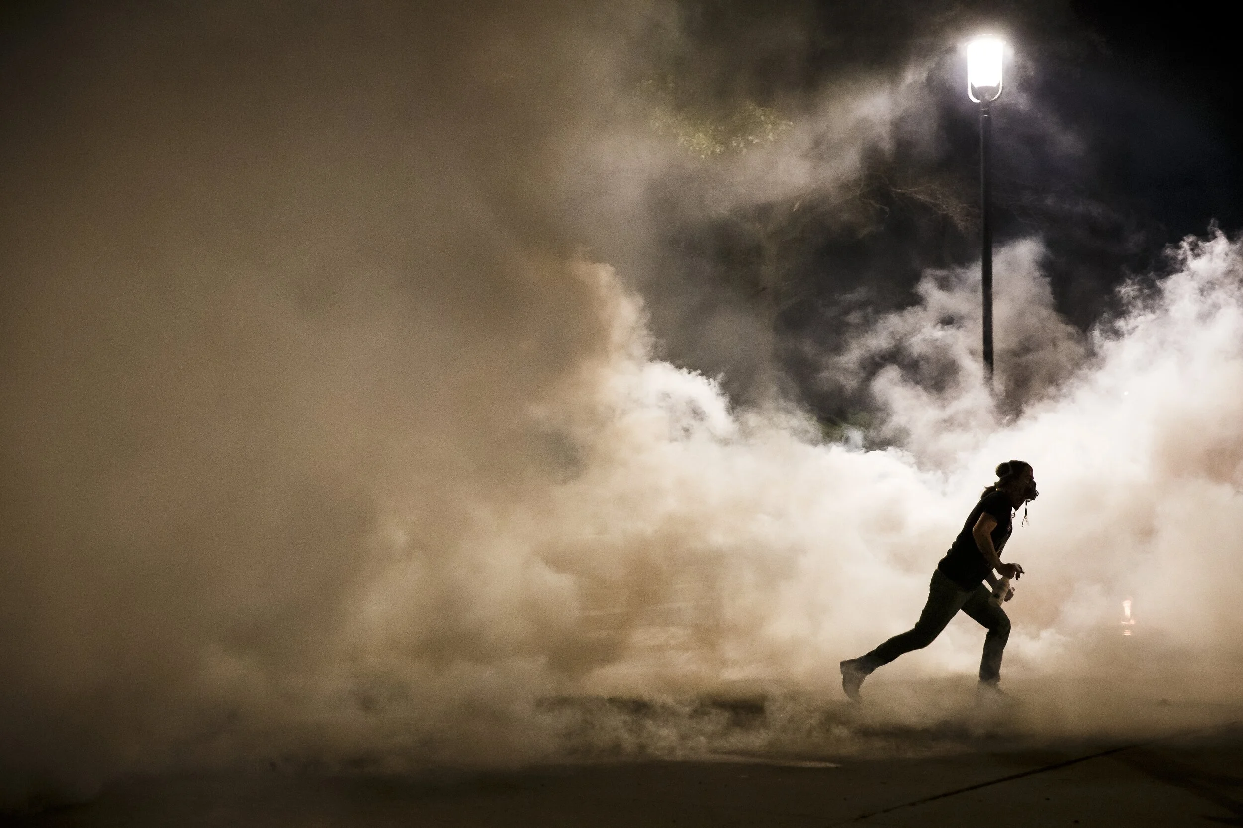  A protestor runs from a cloud of tear gas on the steps of the Iowa State Capitol on Saturday, May 30, 2020 in Des Moines. The second night of protests echo the protests around the country following the death of George Floyd in Minneapolis.   