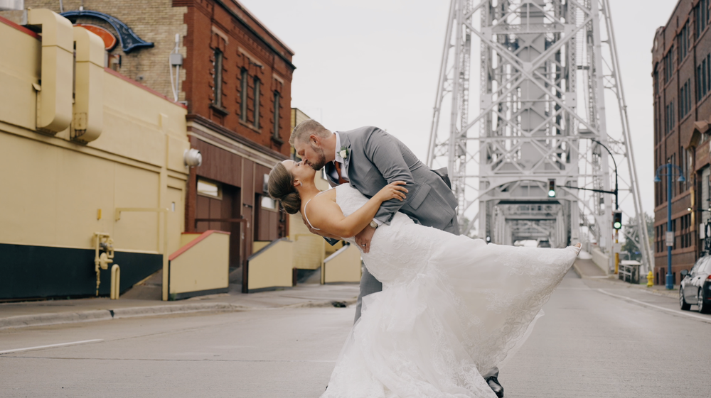 Bride and groom dip kissing by the Duluth lift bridge.png