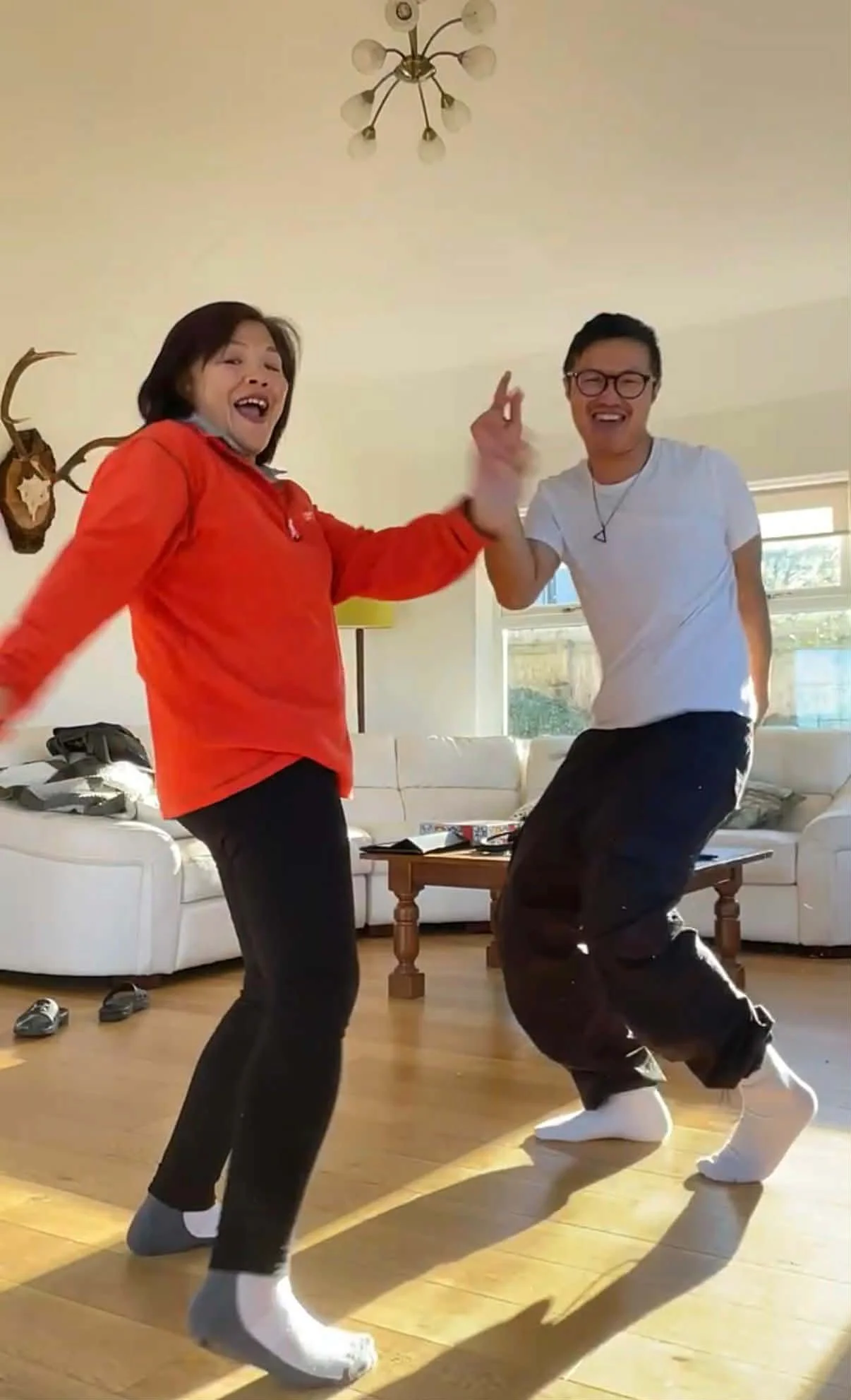 Lewis dancing in the living room with his mum