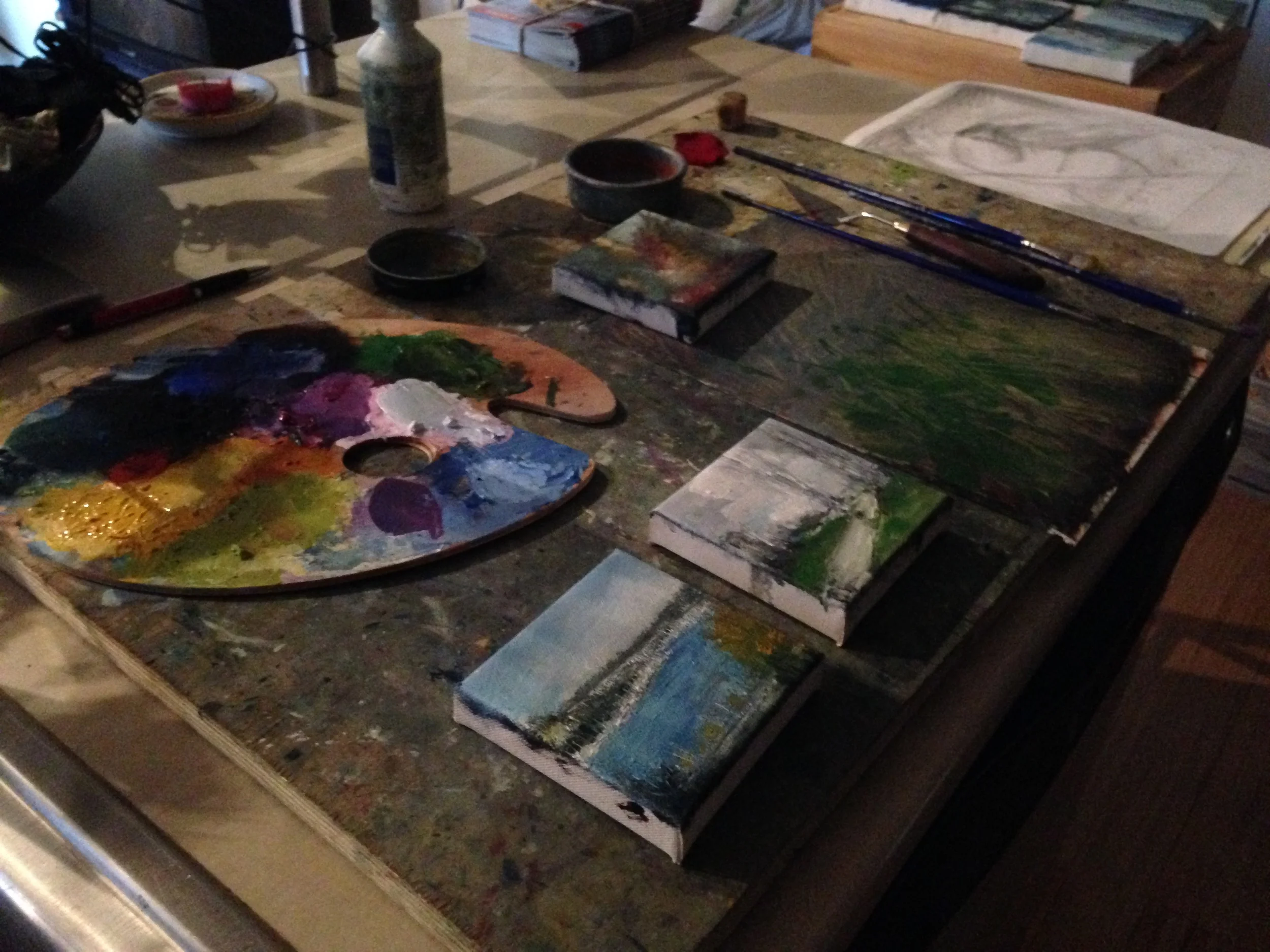 Signing paintings.