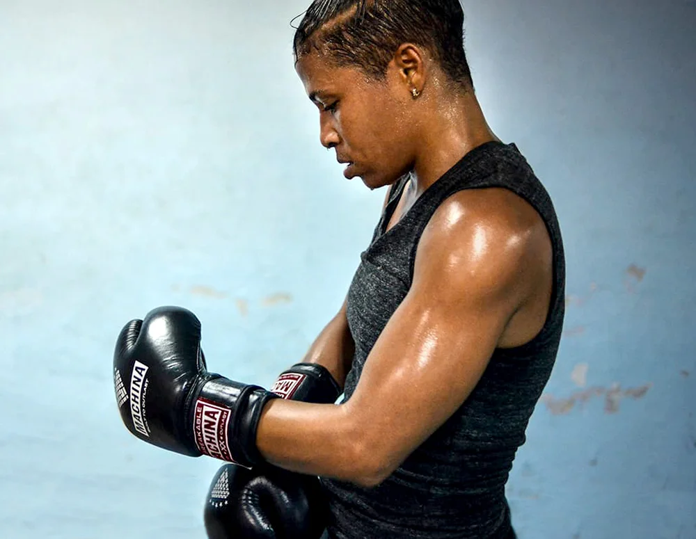 Namibia Flores strapping on her... yes! those are Machina boxing gloves!