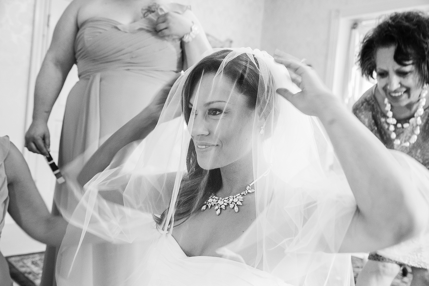 Bride putting her veil on in the getting ready rooms at Ceresville Mansion