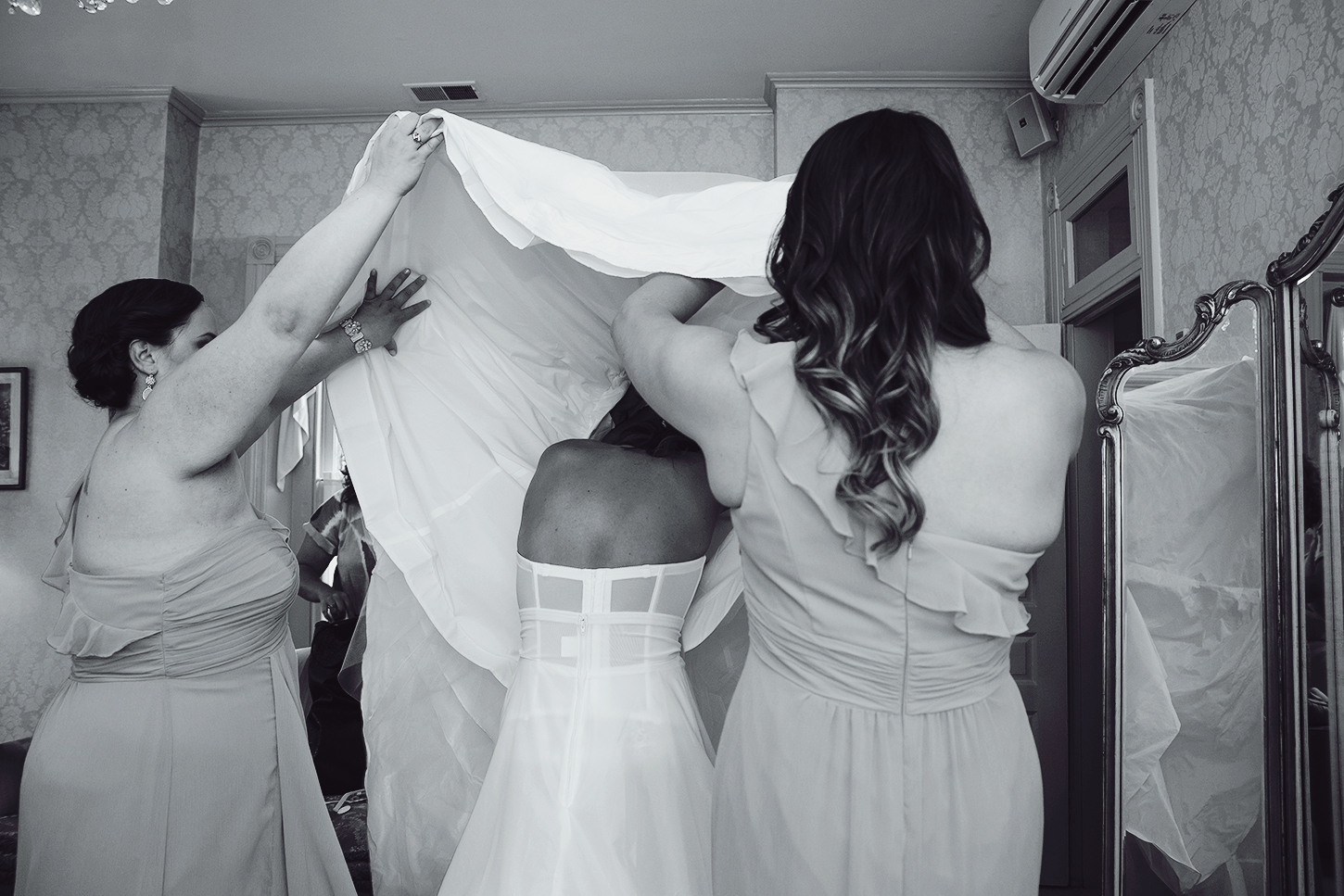 Bride putting on her dress in getting ready suite at Ceresville