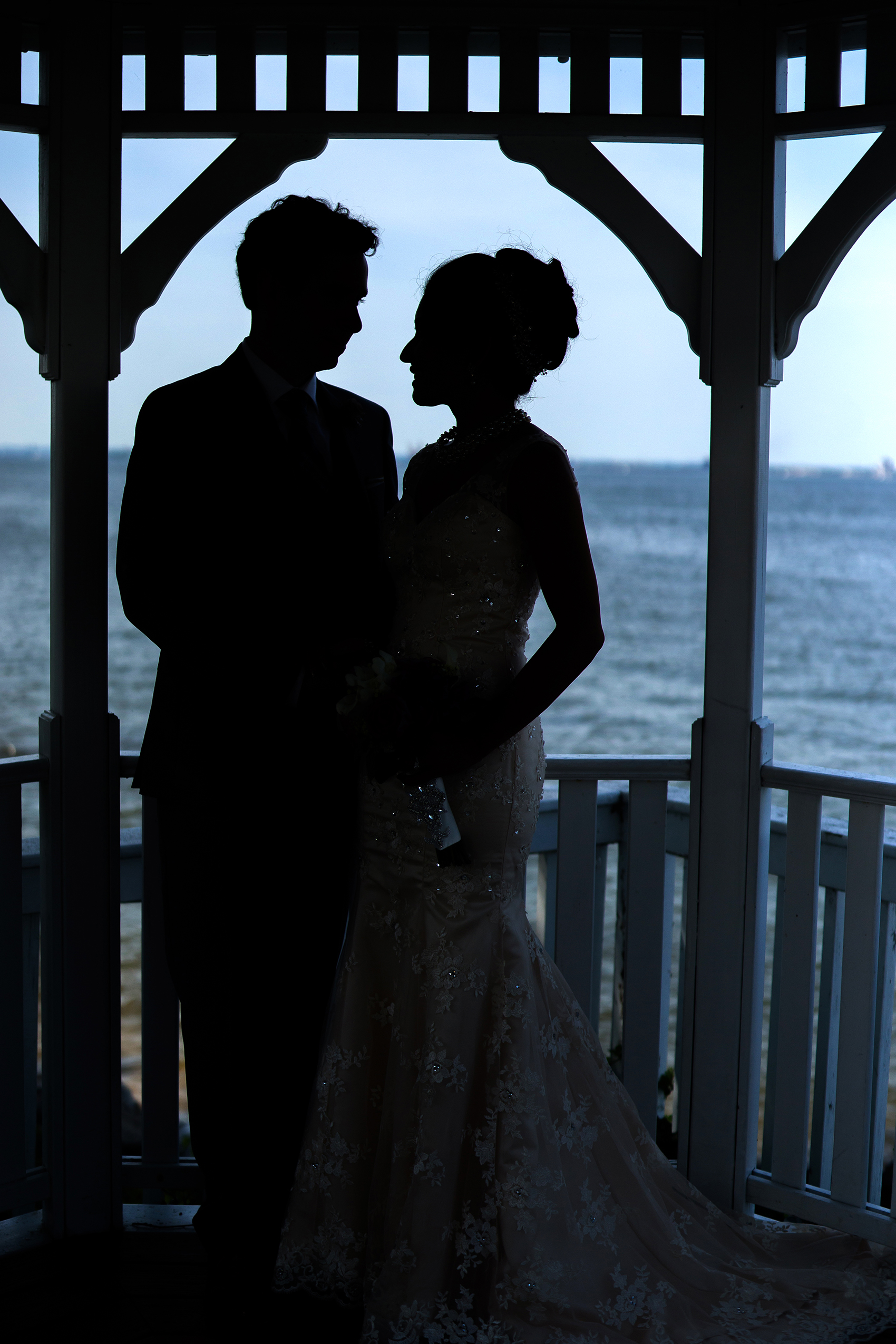 bride and groom silhouette on ocean celebrations at the bay 