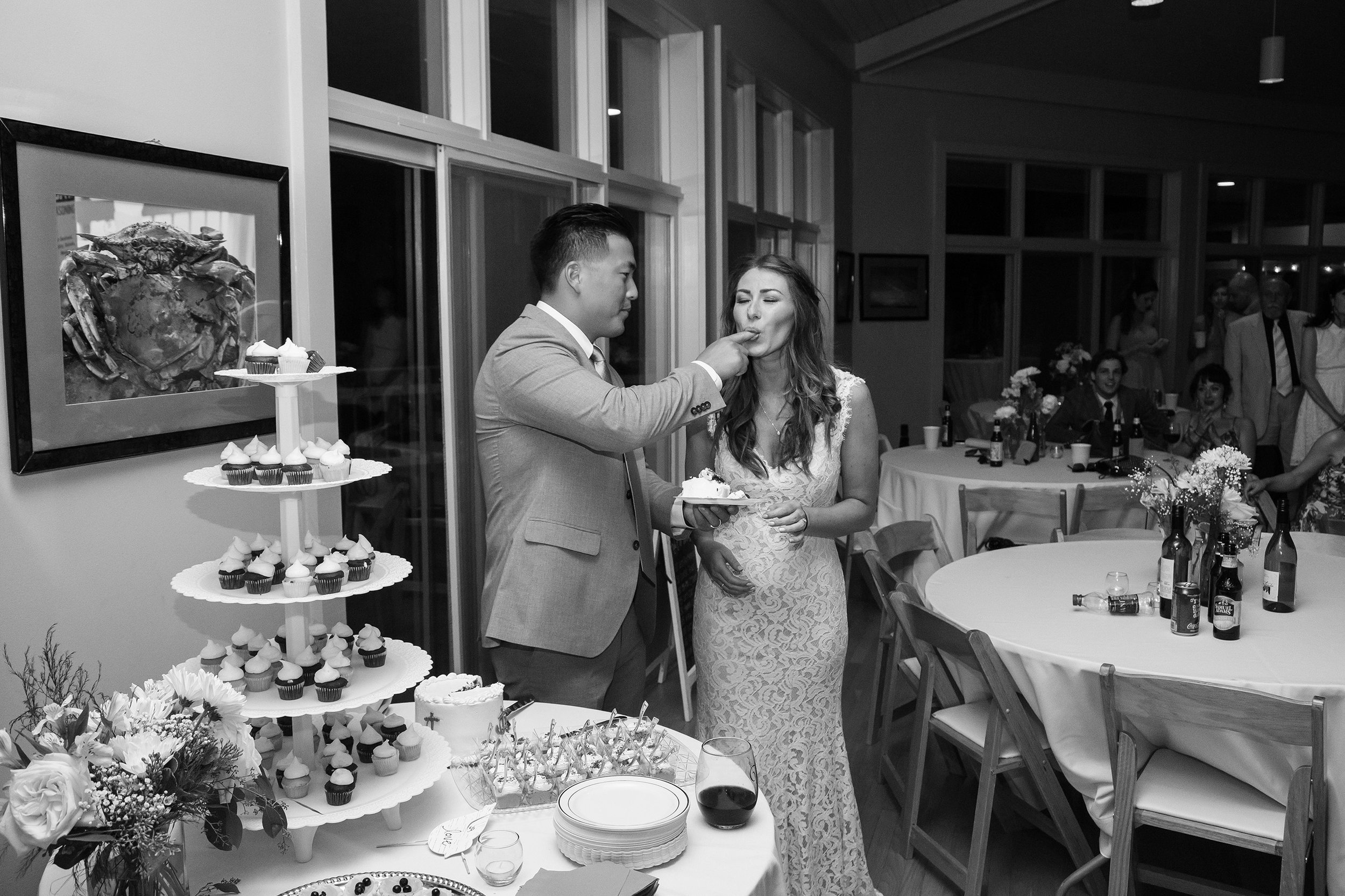 Cake cutting and groom feeding the bride