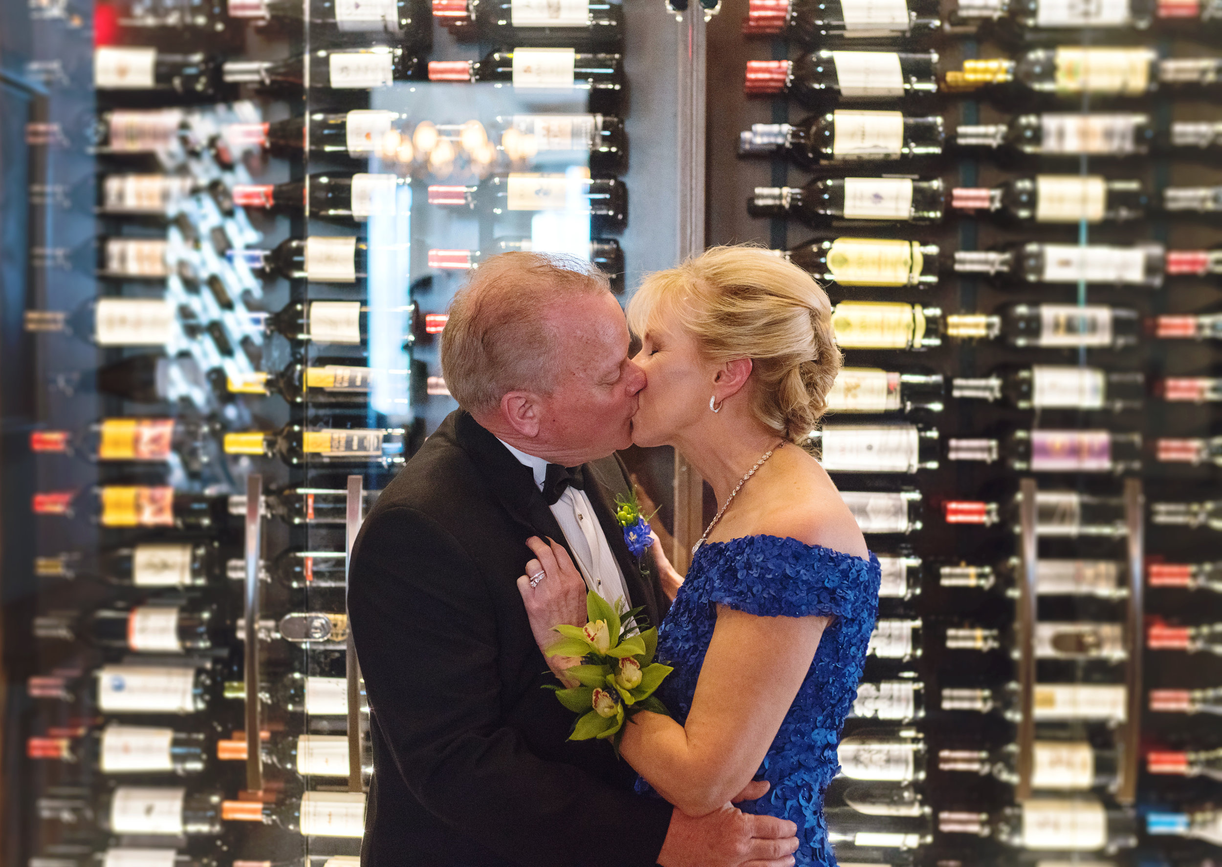 Bride and groom in front of the wine wall at a Ruths Chris in Gaitherburg MD
