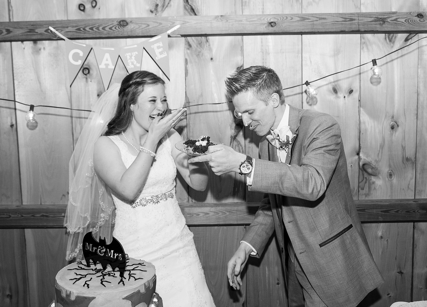 Bride and groom cutting cake at Steppingstone Museum Barn in winter