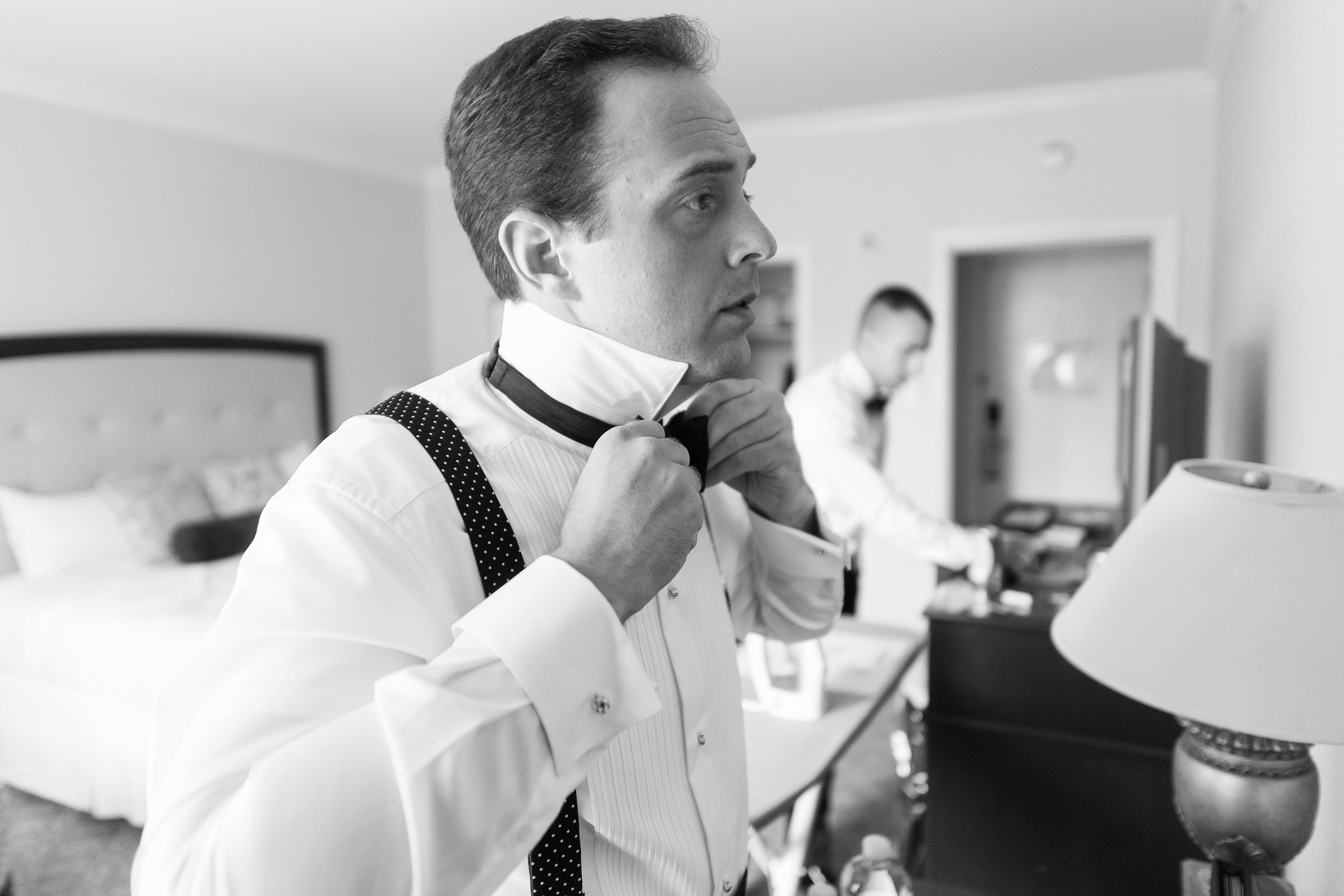 Groom getting ready at maryland hotel for cathedral wedding 