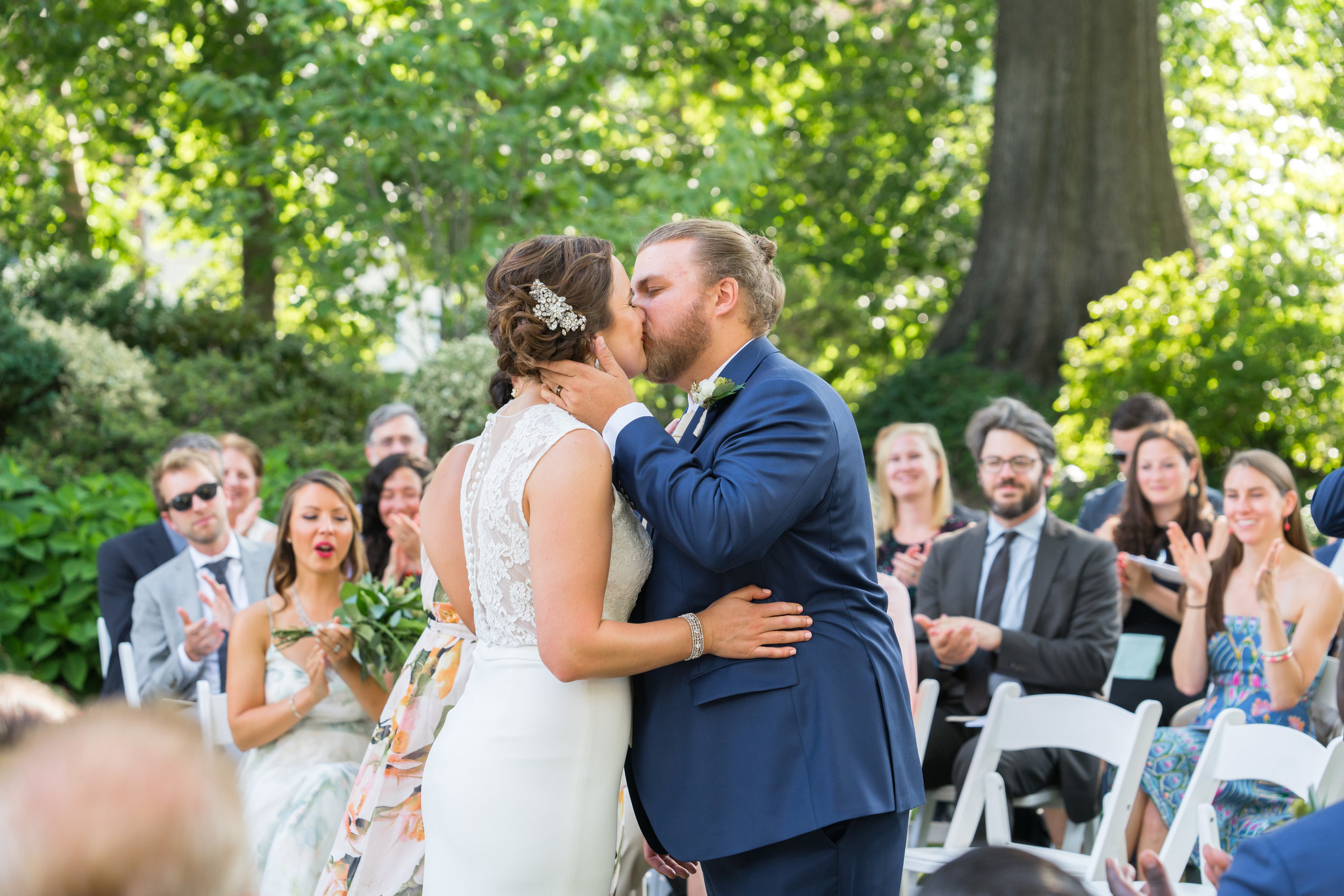 Bride and groom wedding ceremony kiss at meridian house