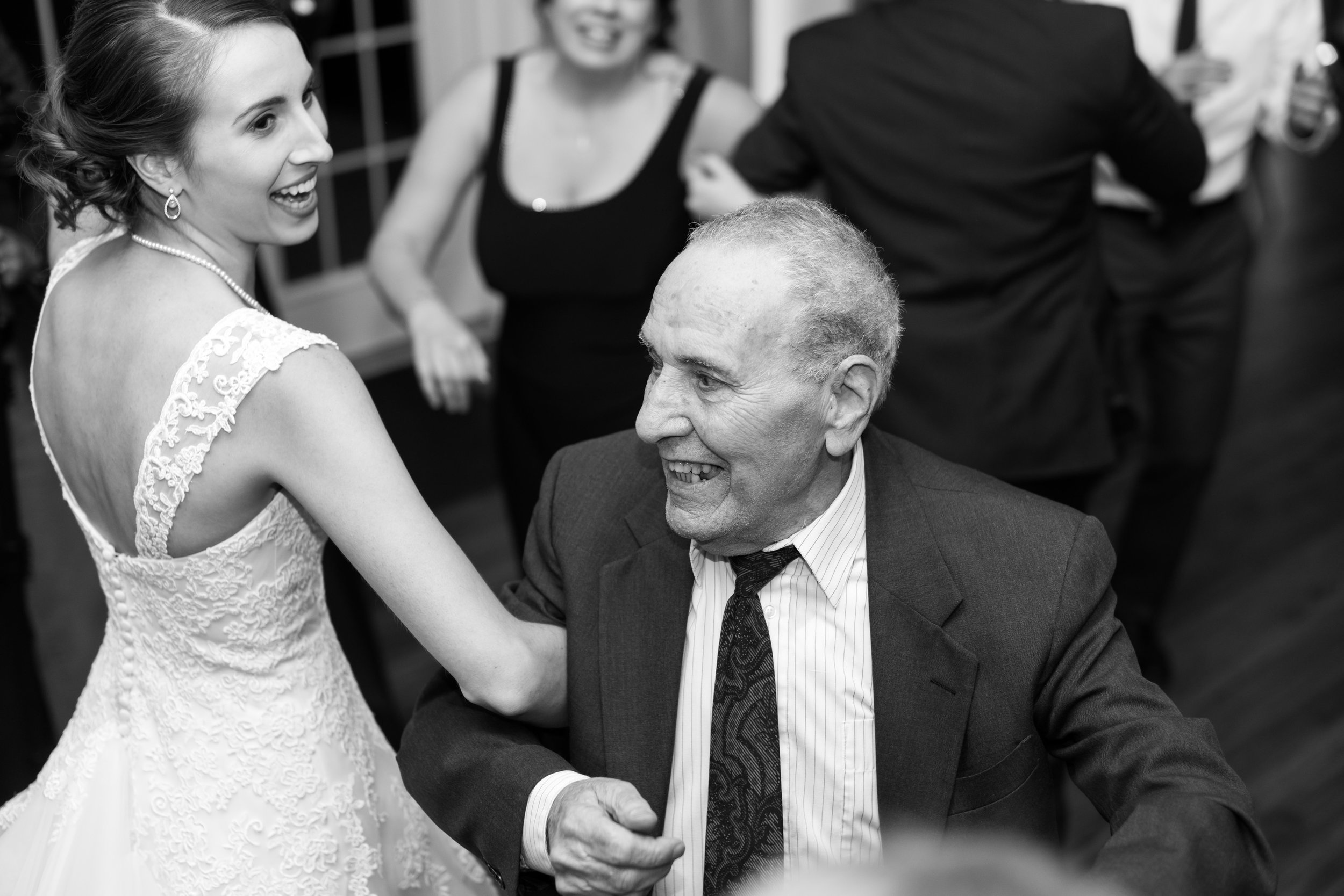 Black and white photo bride and grandpa dancing