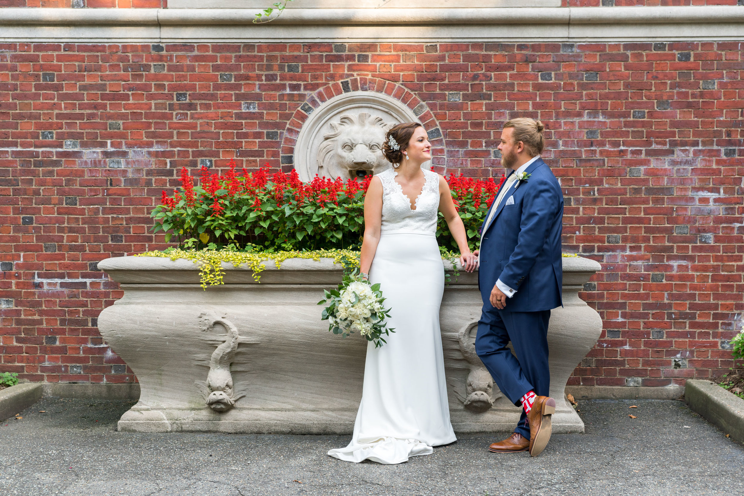 Wedding ortraits by a brick wall next to meridian house