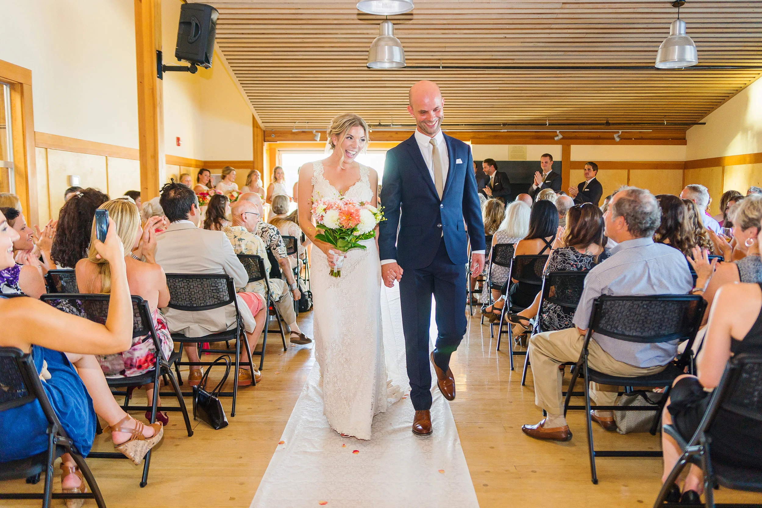 Bride and groom walking down the aisle at mt baker rowing sailing center