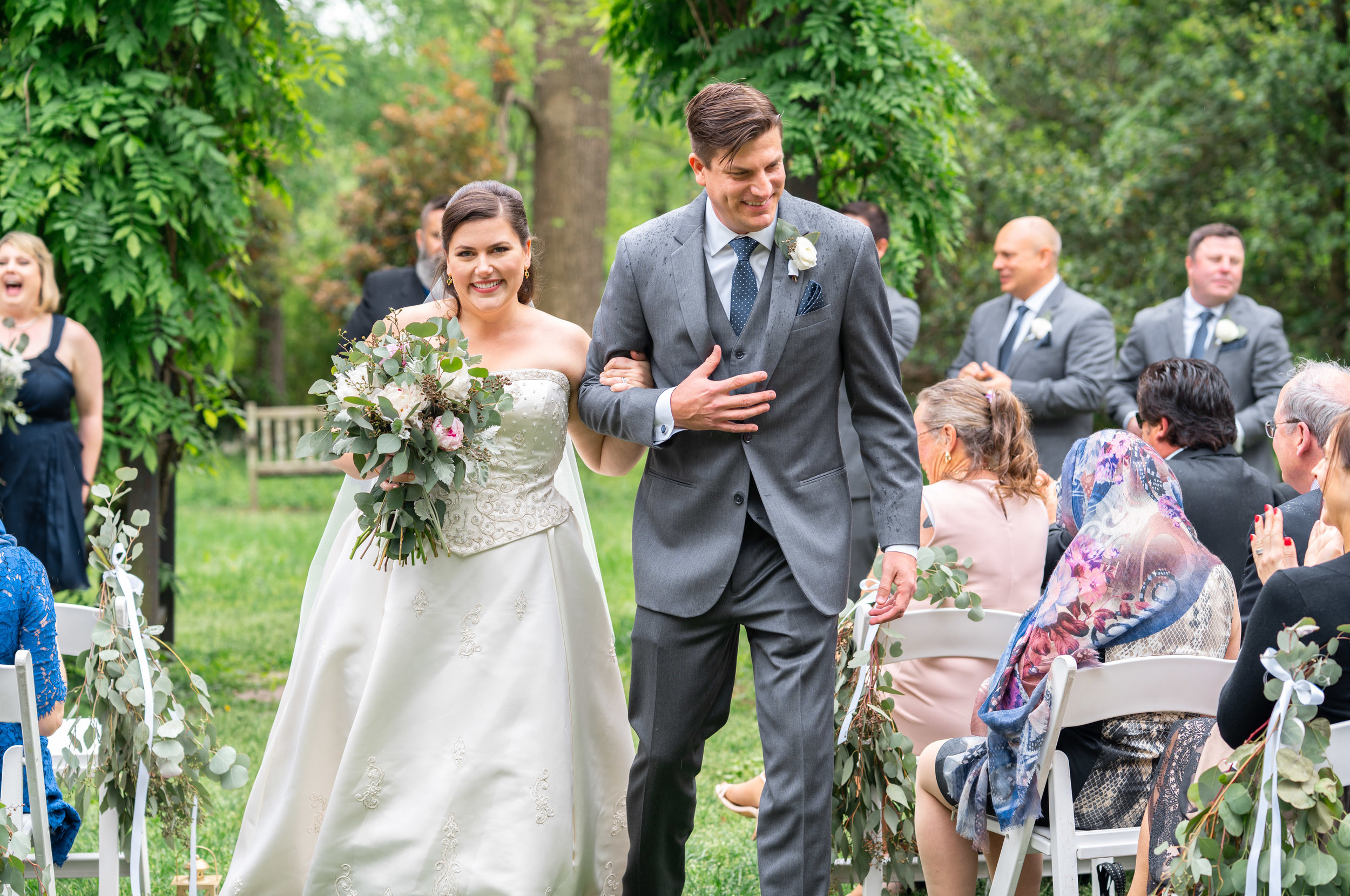 Bride and groom walking back down the aisle at Hendry House wedding