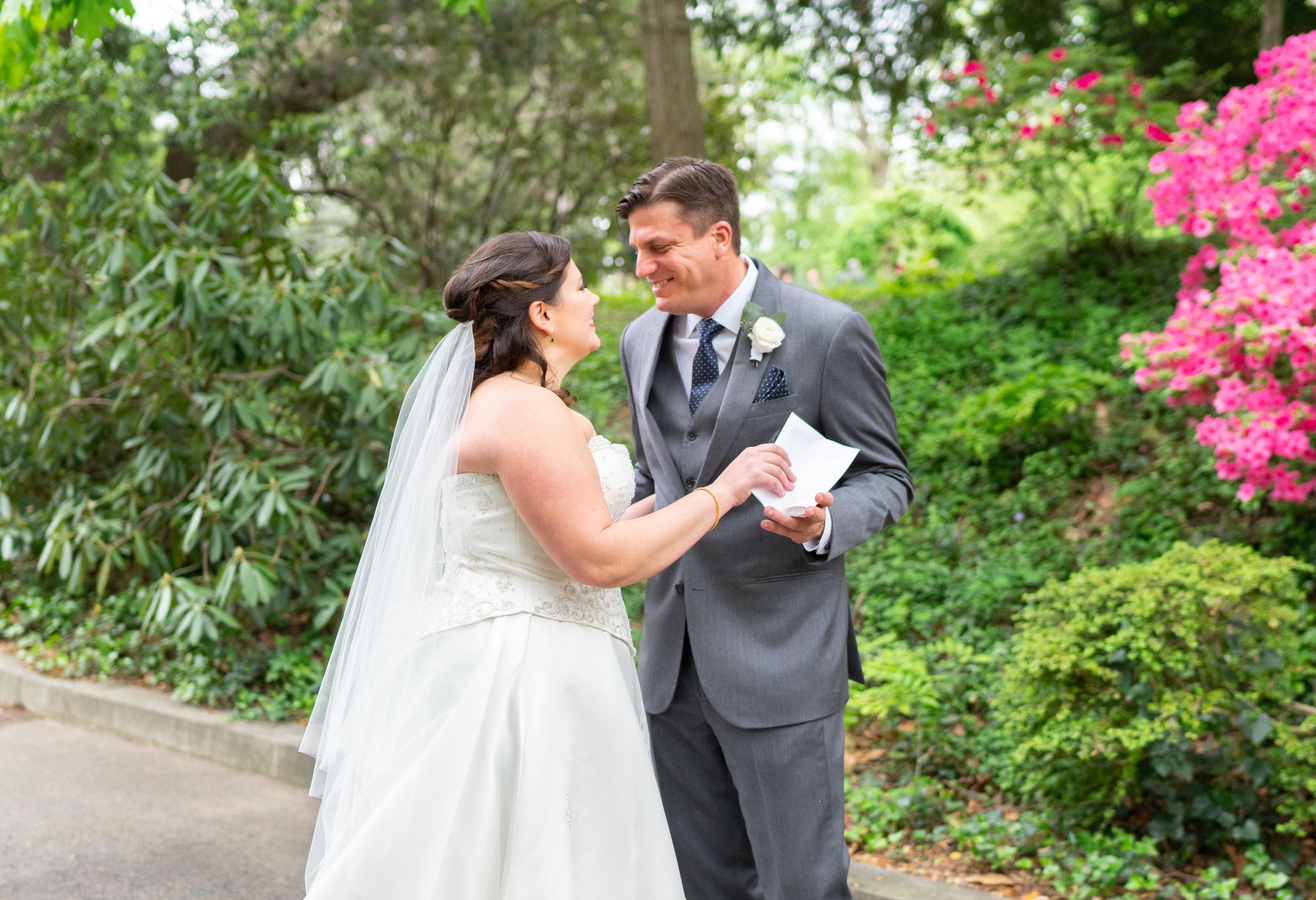 Bride giving her groom a letter during their first look at Hendry House 