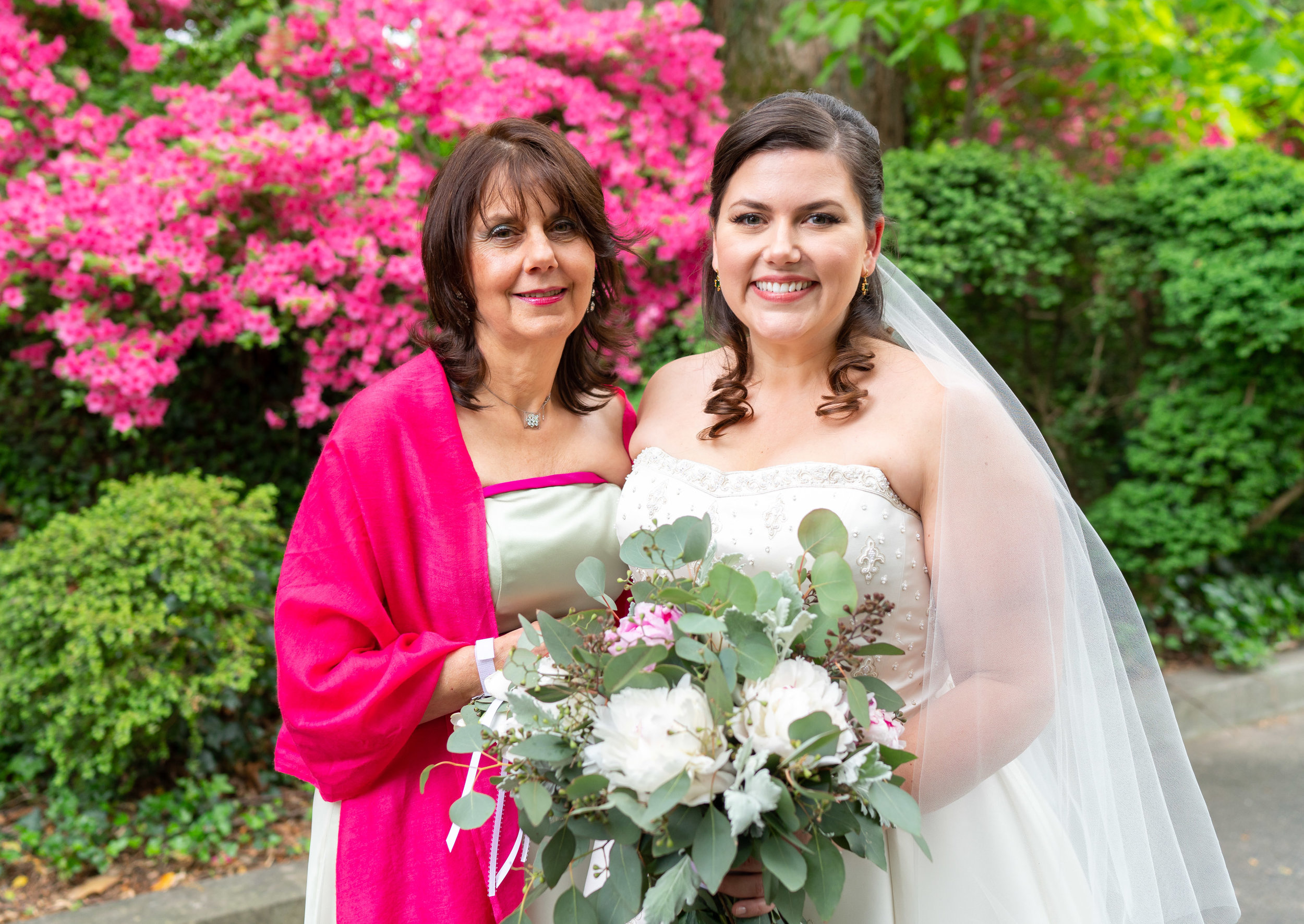 Bride and her mother in front of pink azaleas at Hendry House wedding