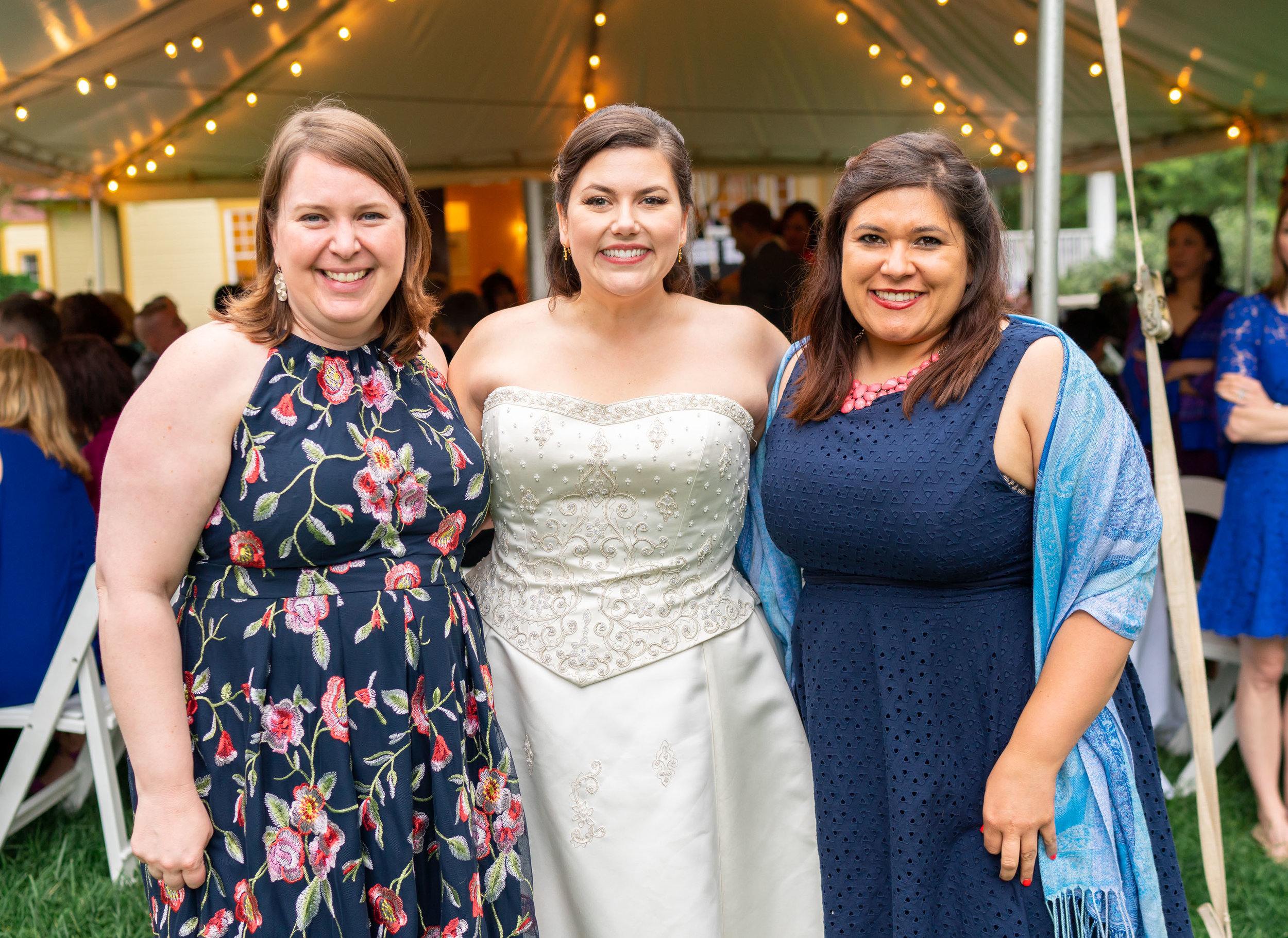 Bride and her friends under tent reception at Hendry House wedding