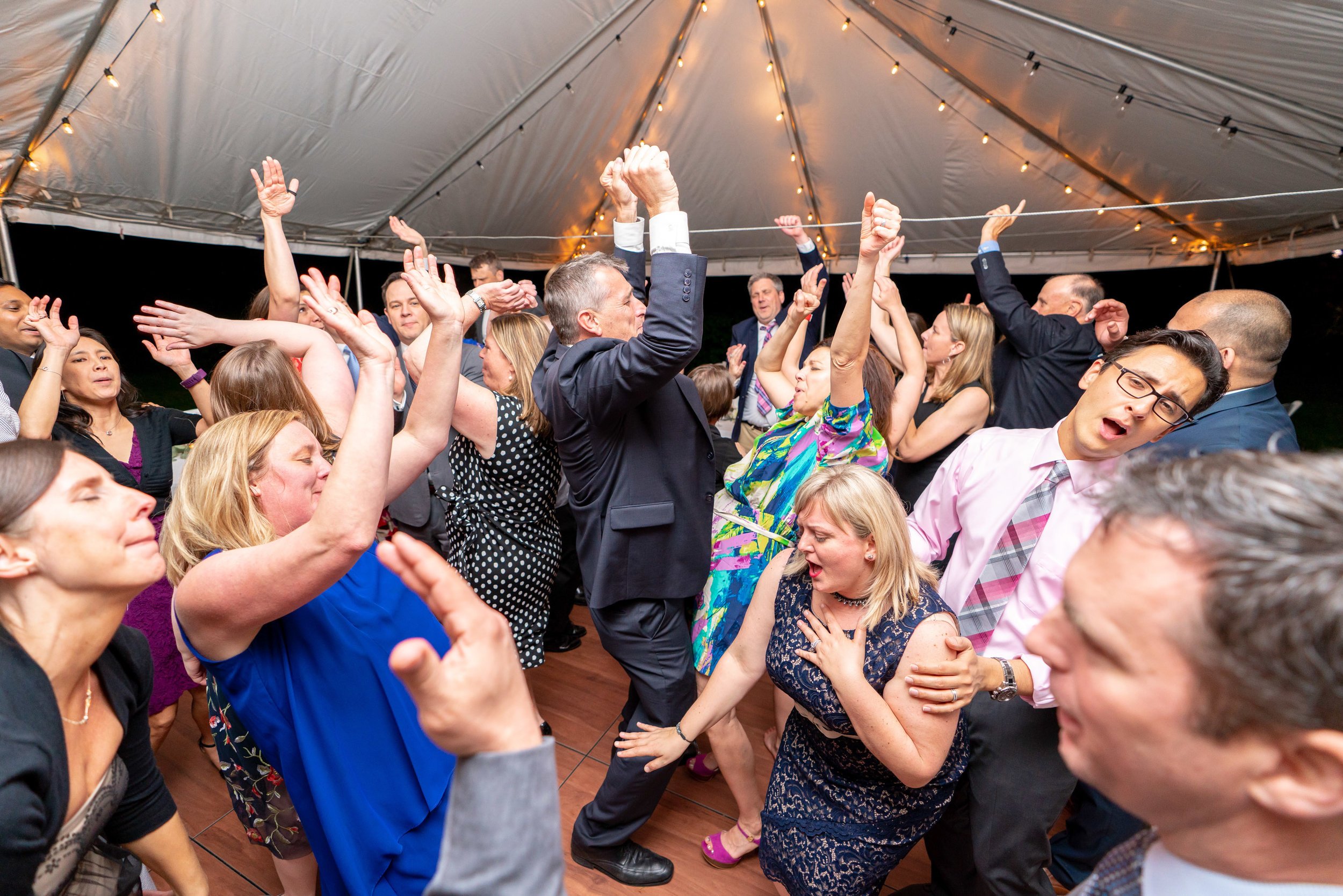 Amazing shot of guests hands in the air at crazy wedding reception at Hendry House