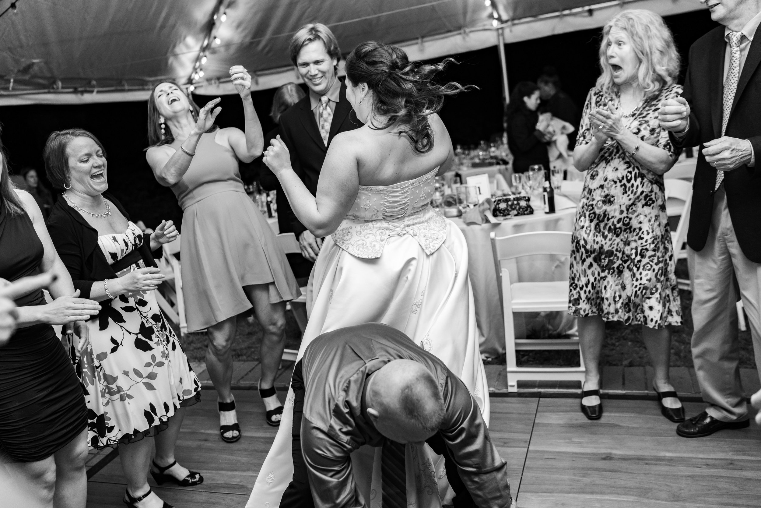 Amazing black and white photo of guests and bride dancing crazy on the dance floor at Hendry House