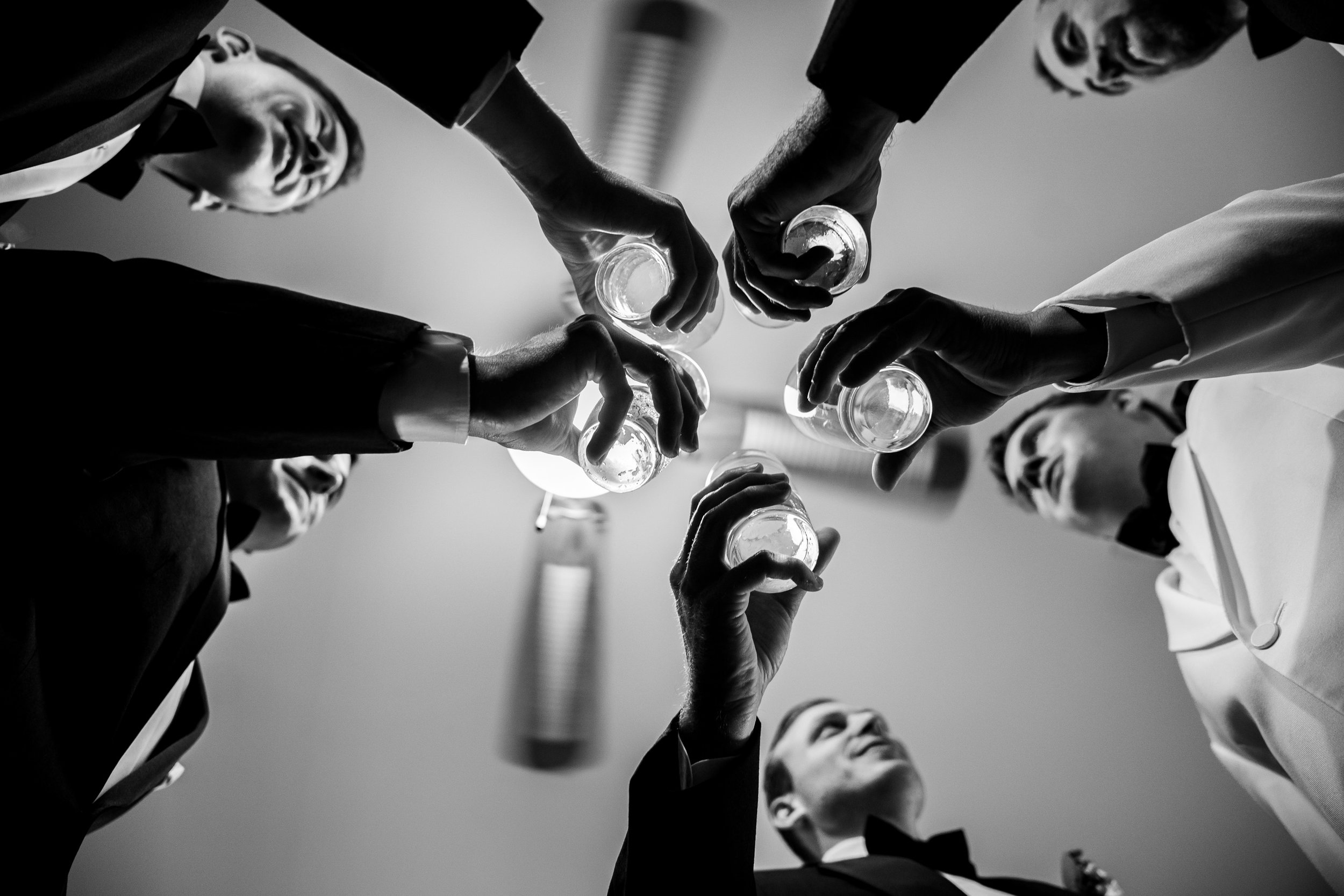 Groom and groomsmen toasting at Harvest House wedding in Leesburg