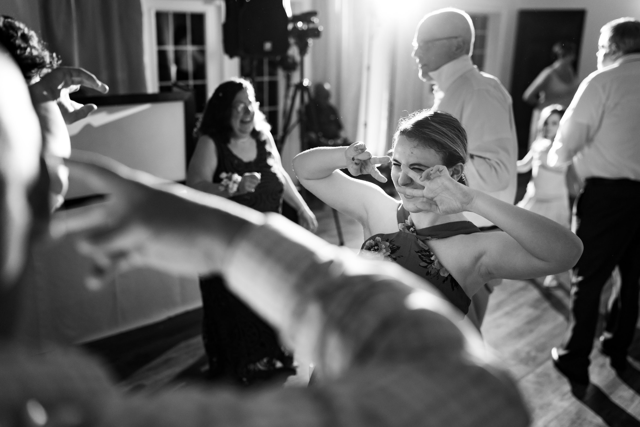 Wedding guests dancing in dramatic black and white photo