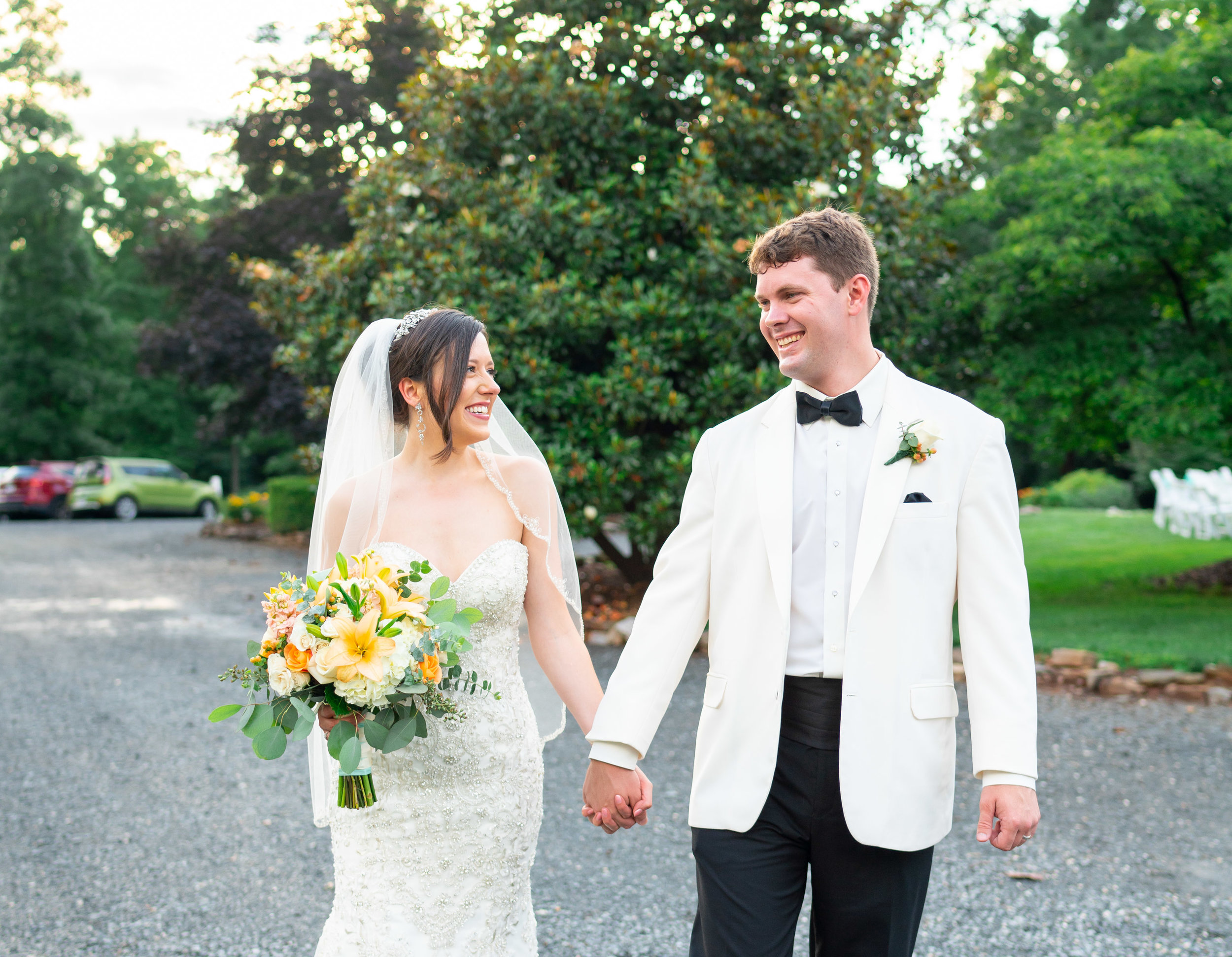 Bride and groom walking down gravel path at Lost Creek Winery