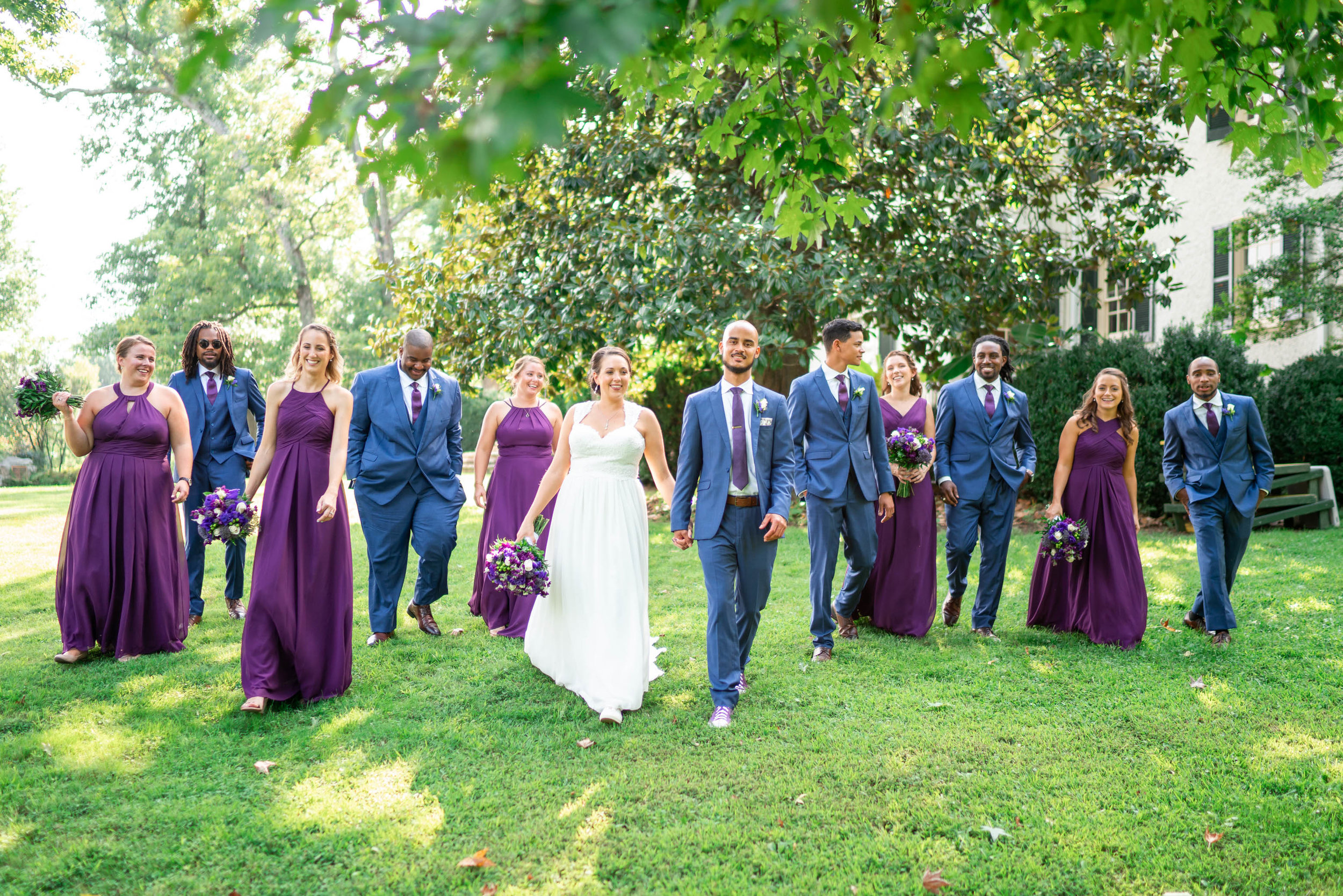Bride and groom and bridal party walking photo at Rust Manor House