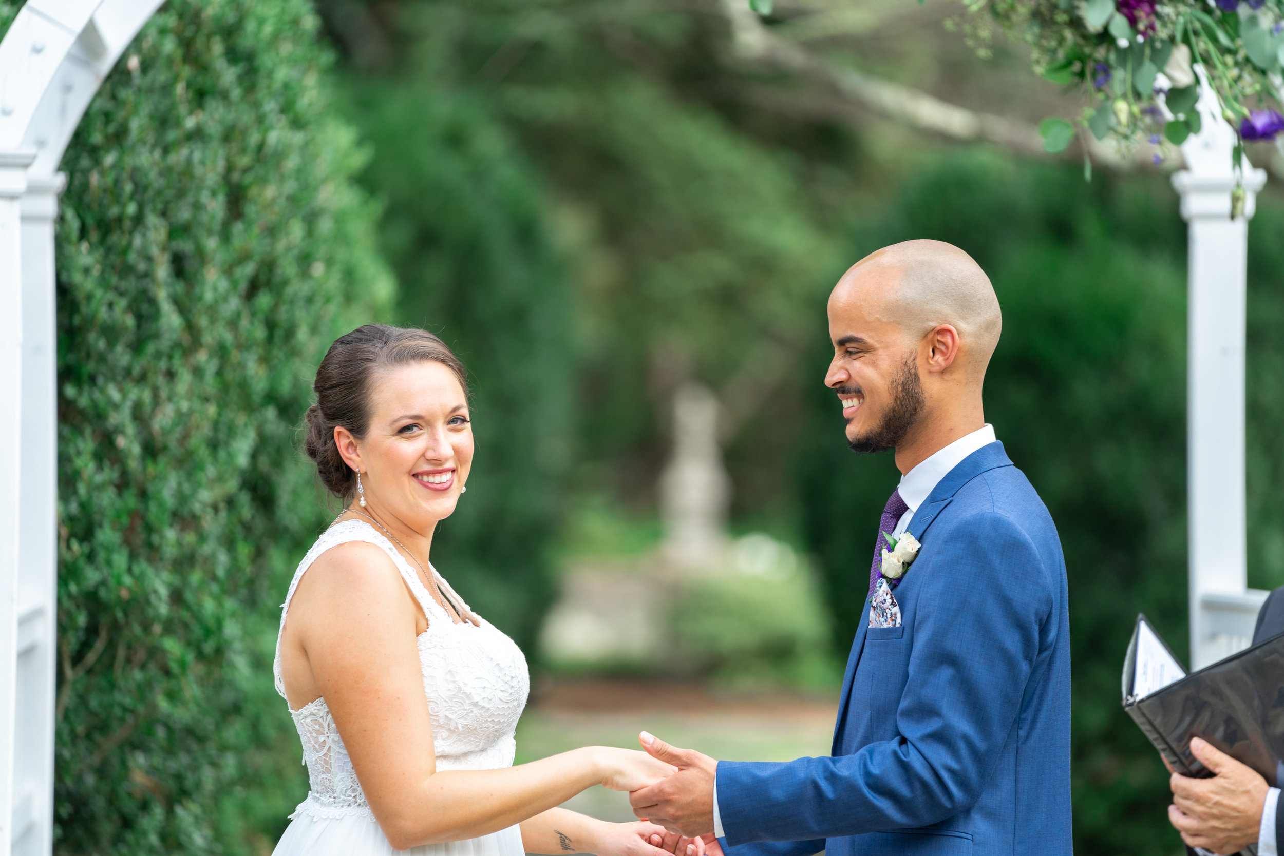 Bride and groom laughing during wedding ceremony at Rust Manor