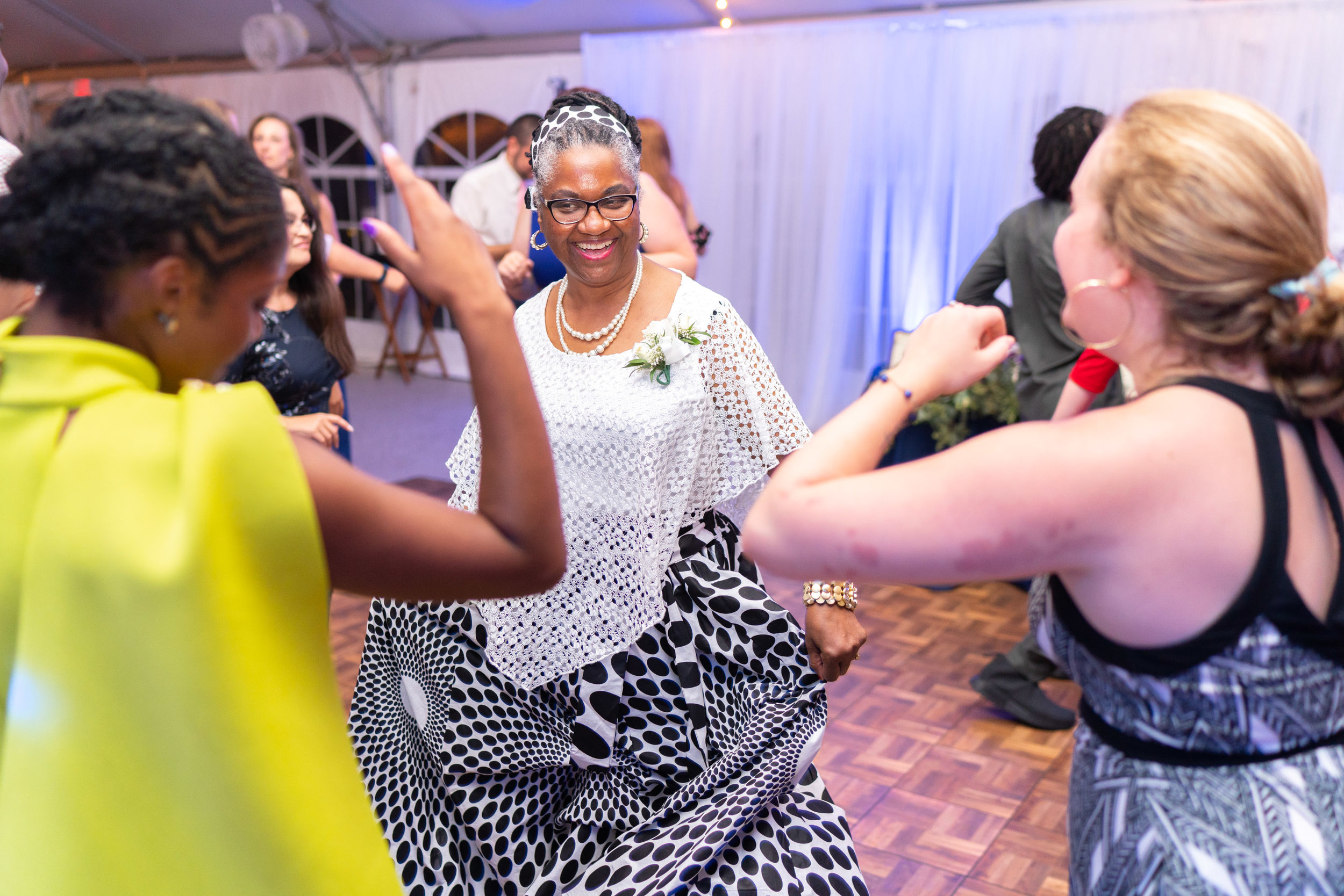Guests dancing in colorful dresses on the dance floor at Rust Manor House