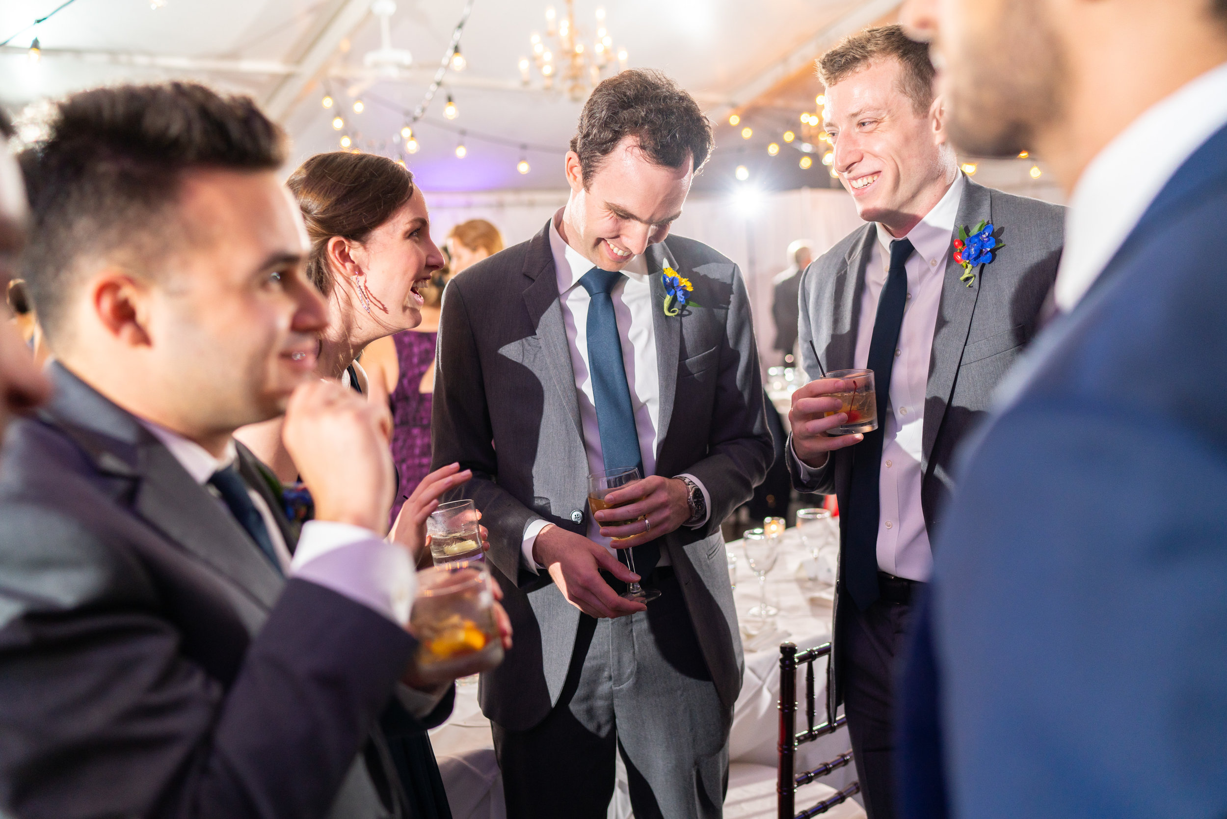 Groom and sister and groomsmen laughing at Elkridge Furnace Inn wedding reception