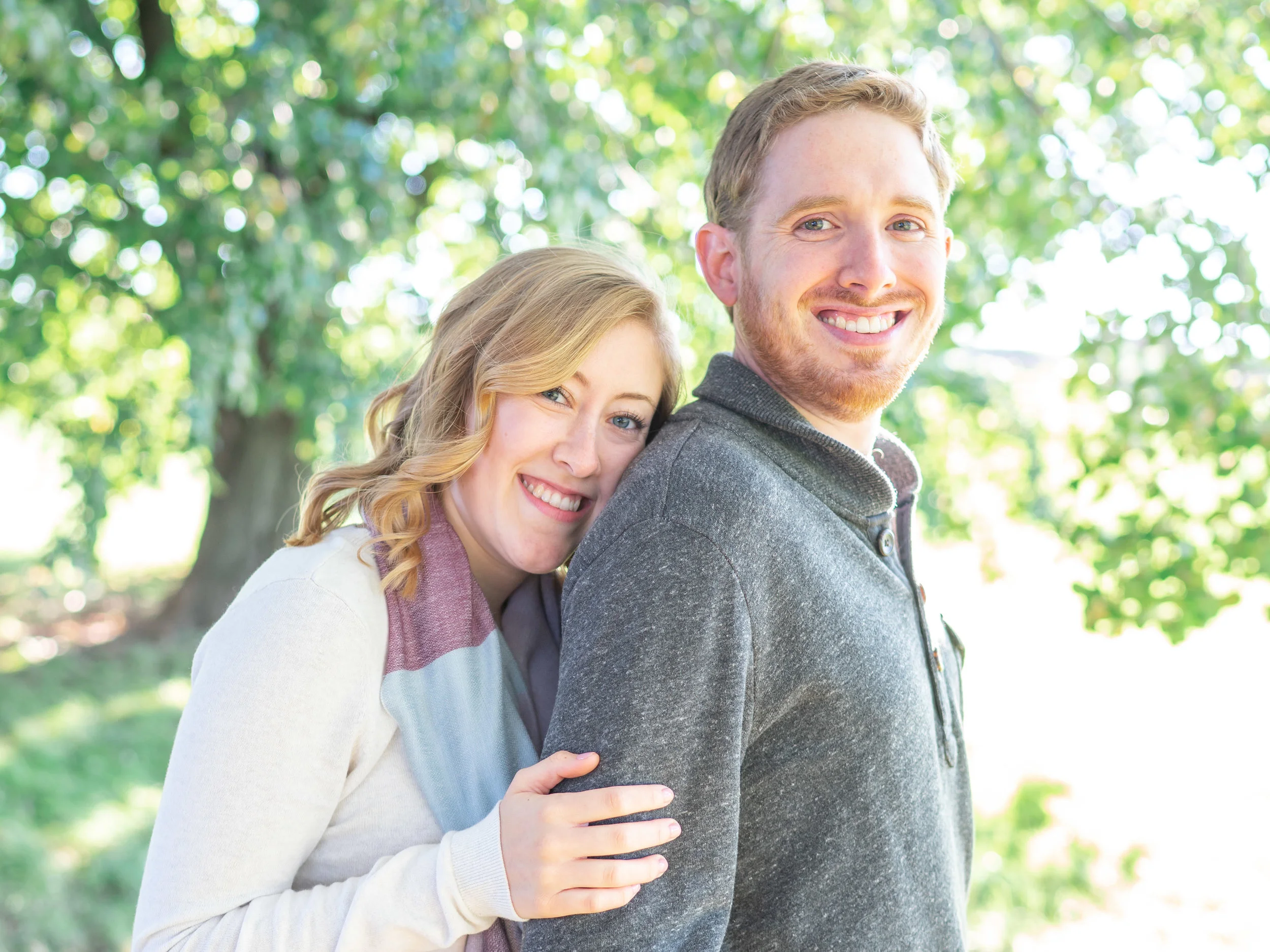 Bride and groom under tree at Fort McHenry engagement session