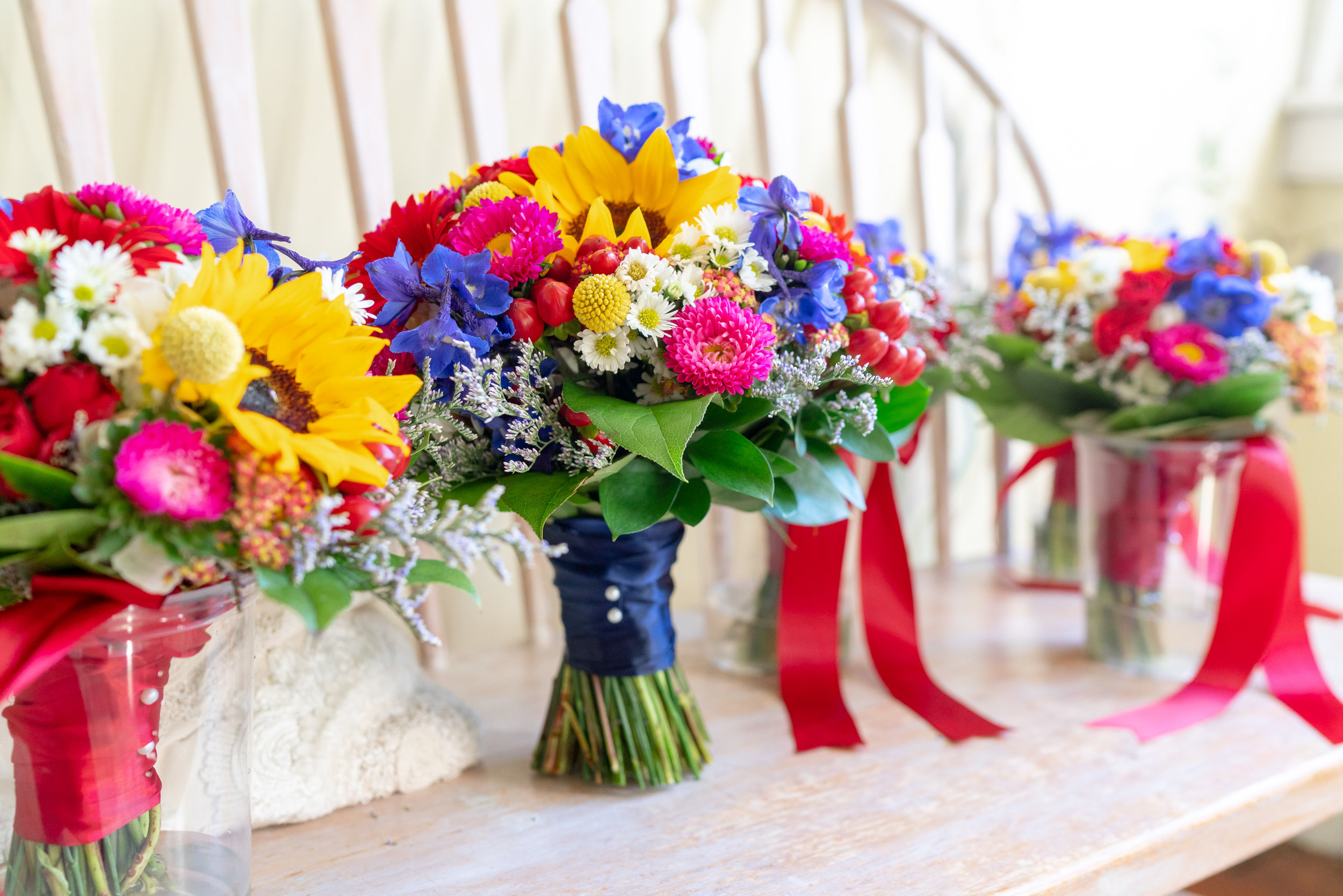 Extremely colorful bouquets by Blossom and Basket Boutique at Elkridge Furnace Inn wedding