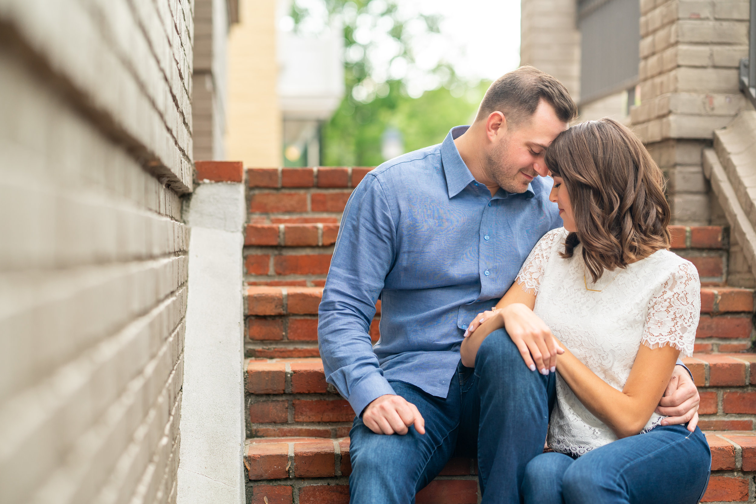 groom nuzzling bride on cobblestone streets in alexandria