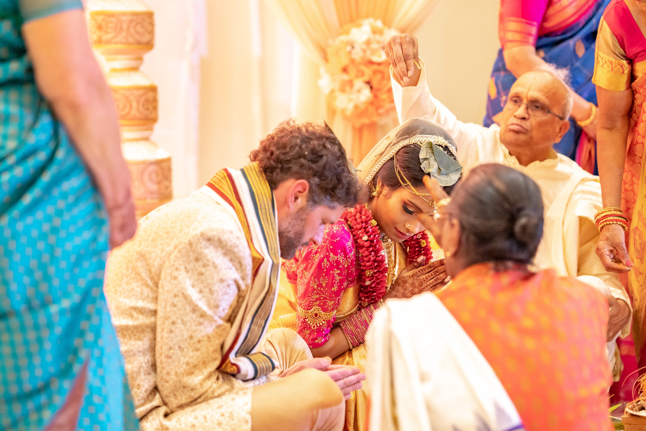 bride and groom bowing during indian wedding ceremony