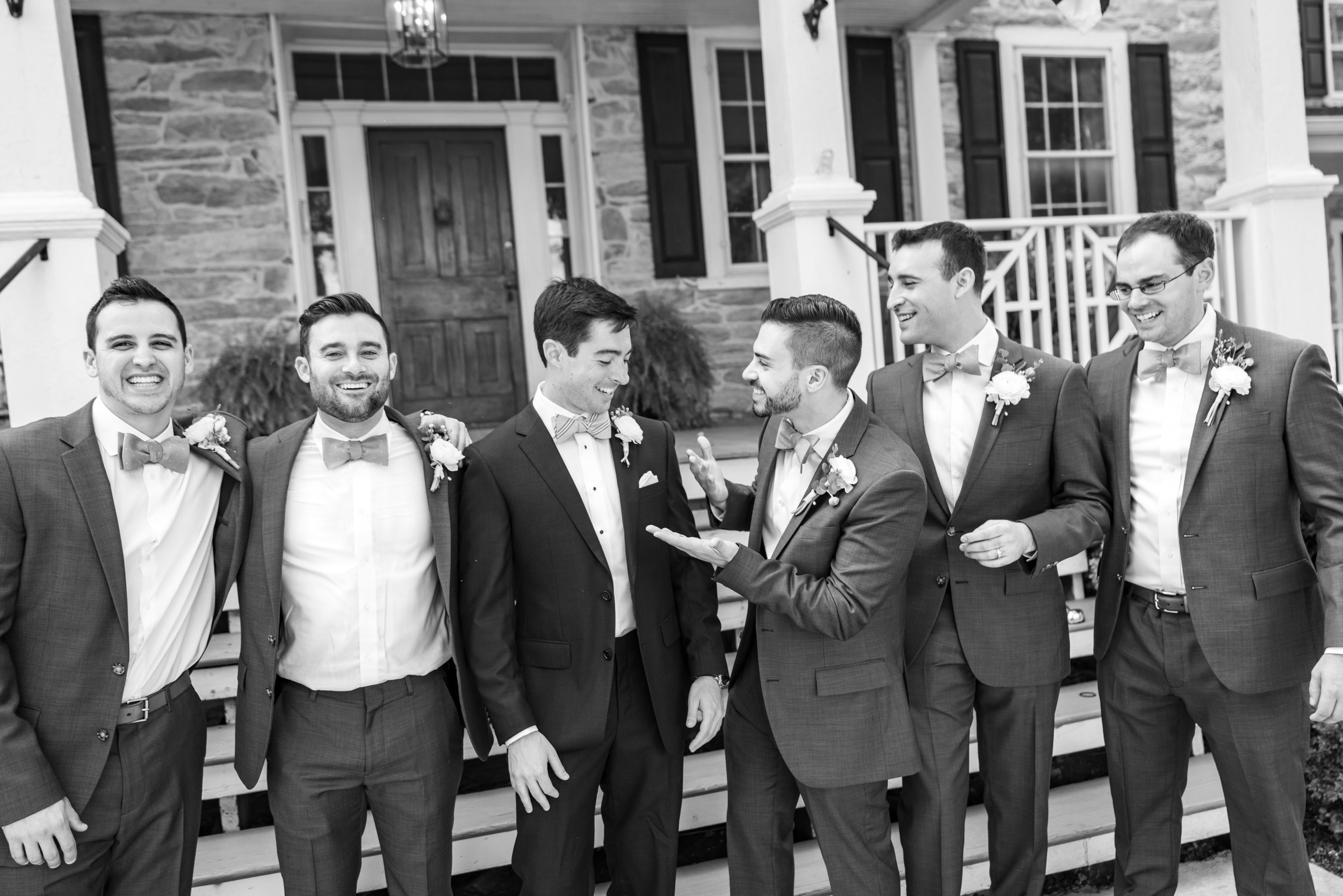 Groom and groomsmen wearing J Crew suits and Tie Bar bow ties at Springfield Manor Winery