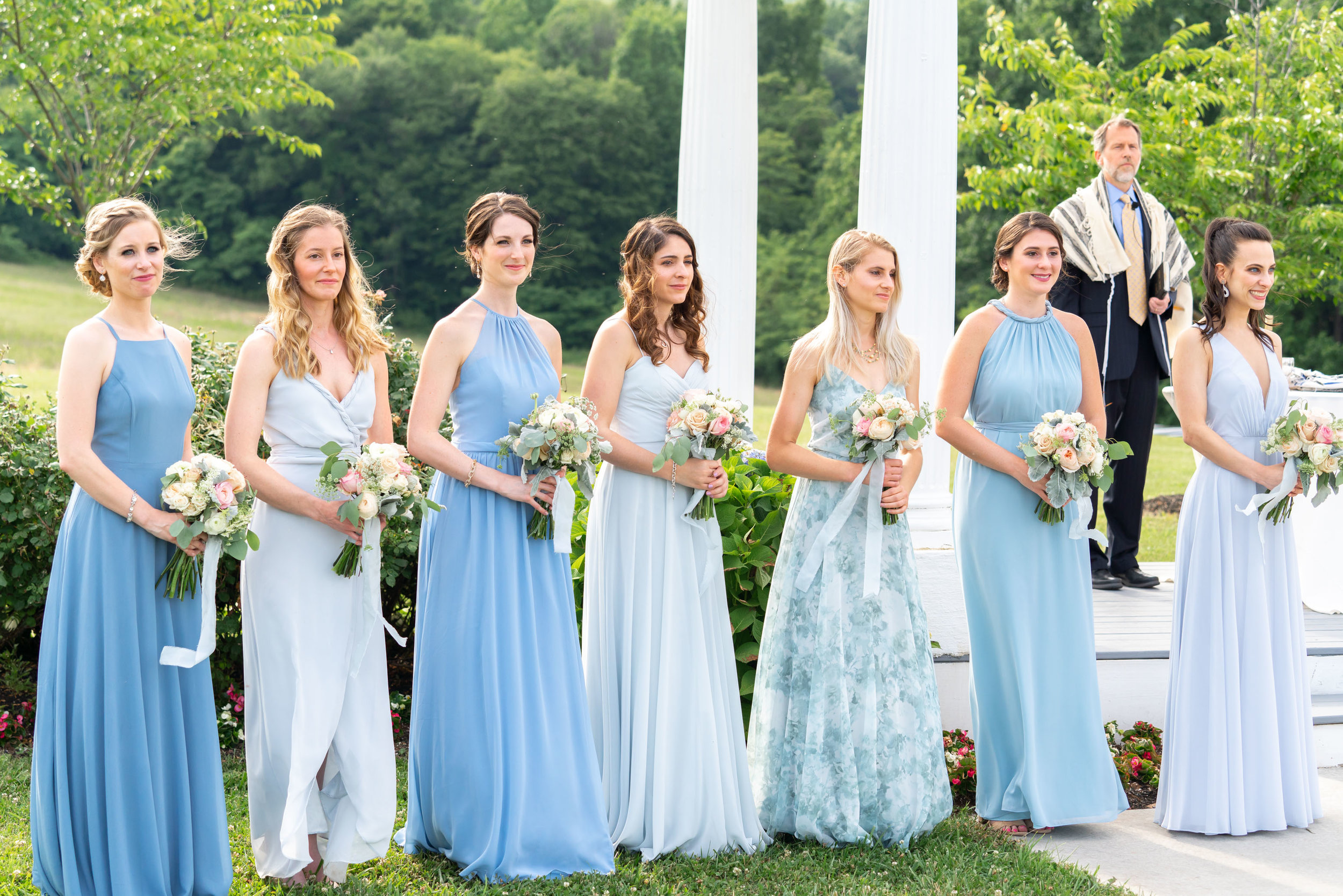 Bridesmaids in light blue dresses from joanna august, jenny you and bhldn. Ceremony site at Springfield Manor