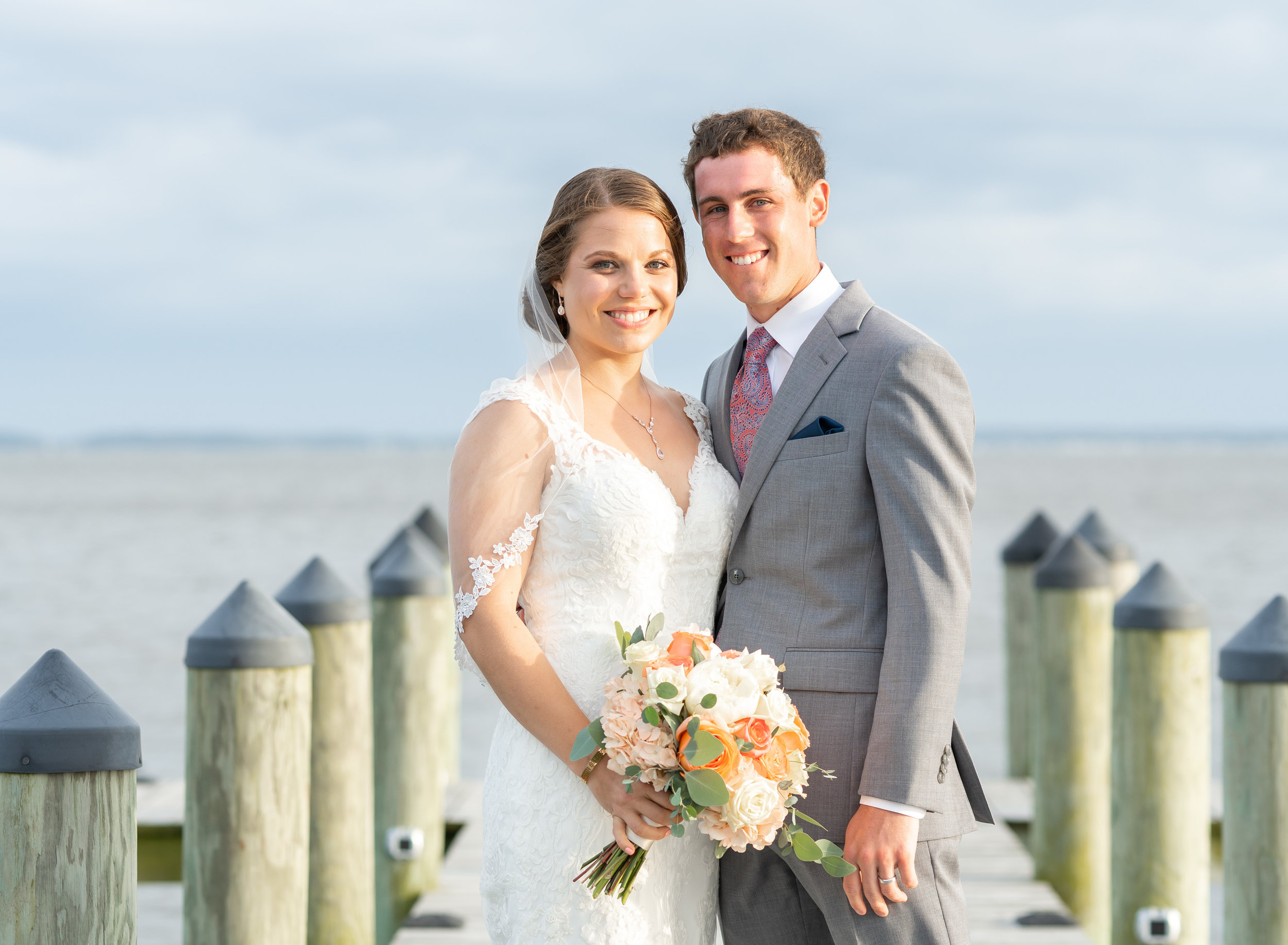 Bride and groom on the dock during sunset at Rehoboth Beach Country Club