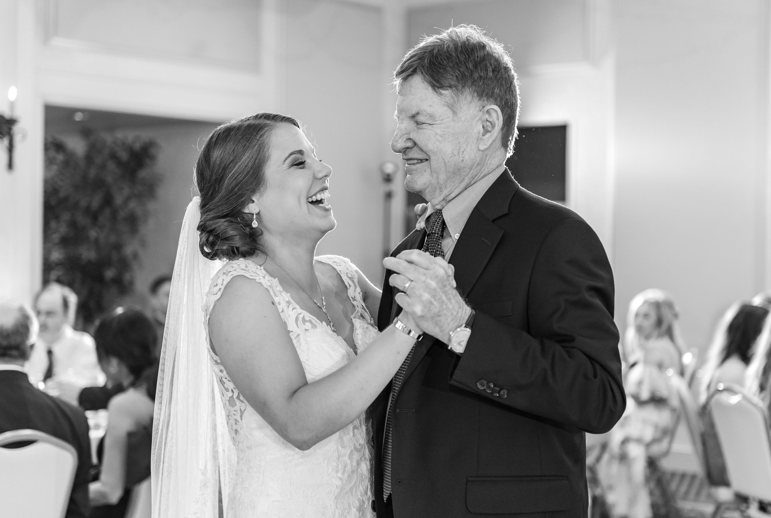 Bride laughs and dances with grandpa at Rehoboth Beach Country Club