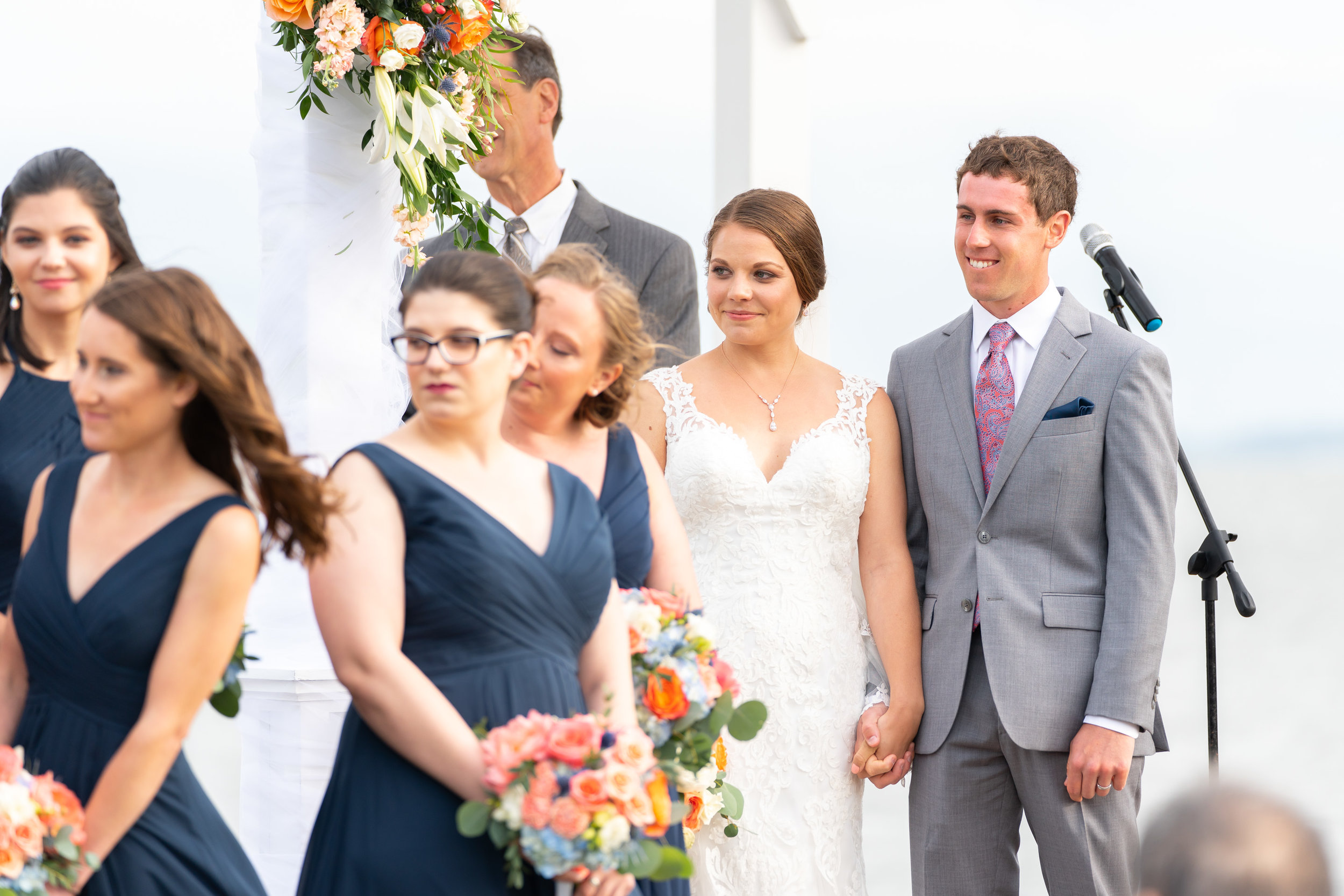 bride and groom watching their friends singing during ceremony