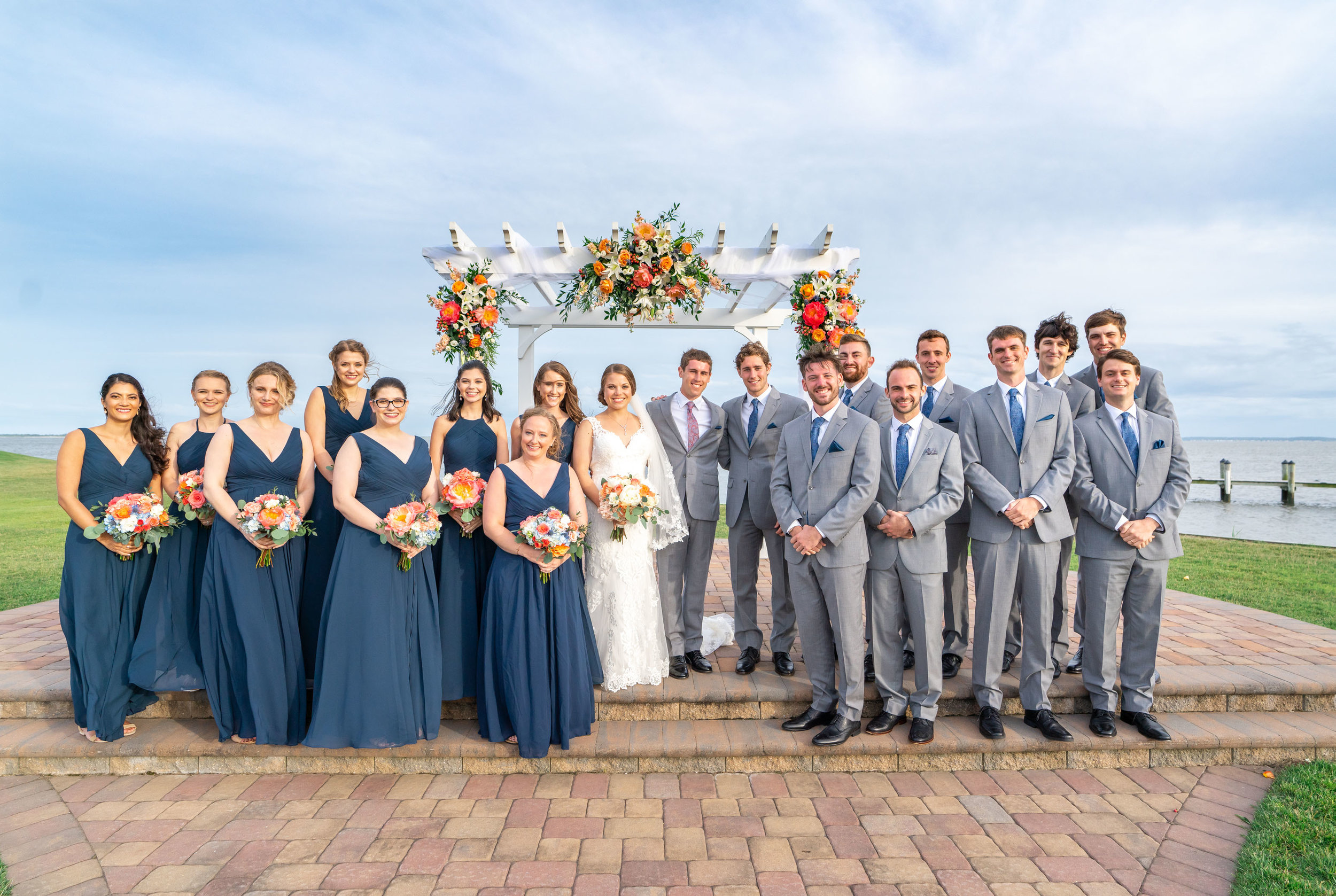 bride groom and bridal party under arbor at rehoboth beach country club