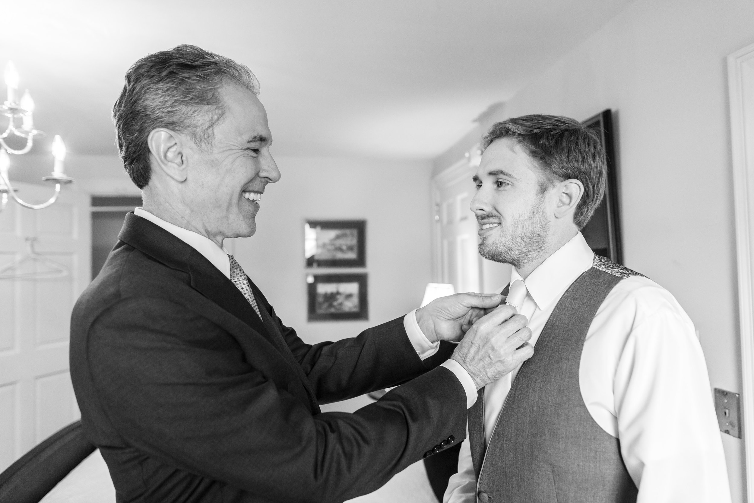 Father and groom in grooms suite at Stone Manor Country Club wedding