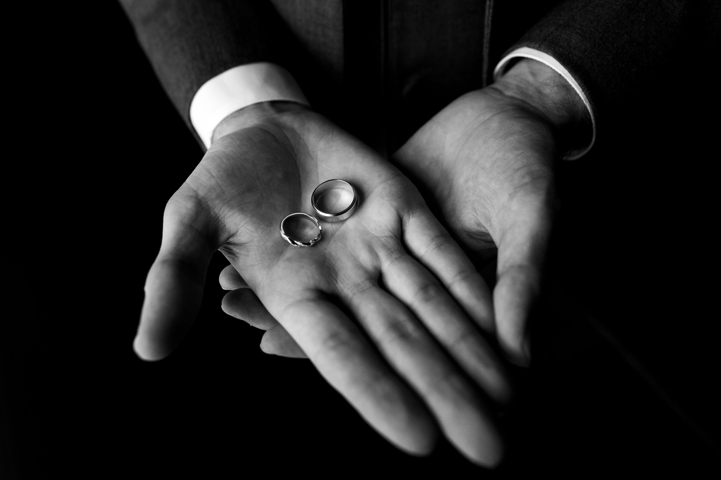 Wedding bands in grooms hand at Stone Manor Country Club