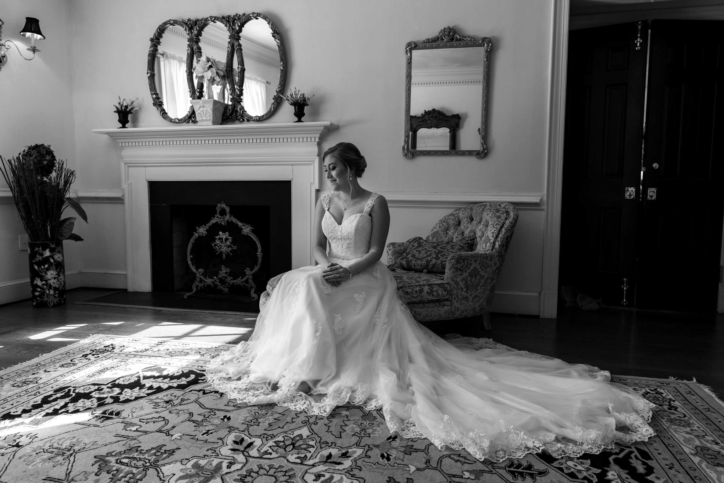 Bride in bridal suite sitting on sofa at Stone Manor Country Club
