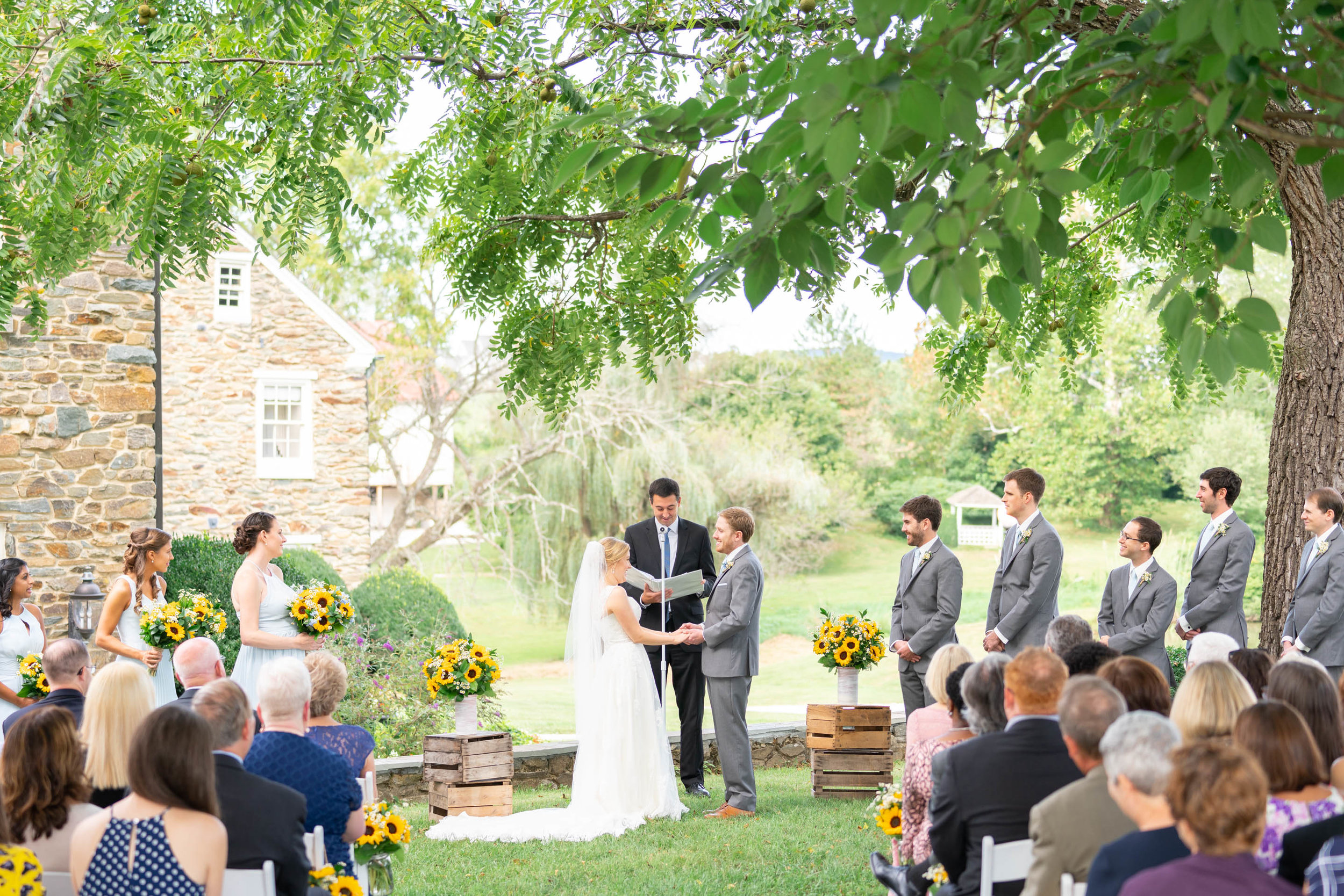 Outdoor ceremony overlooking lake at Stone Manor Country Club wedding