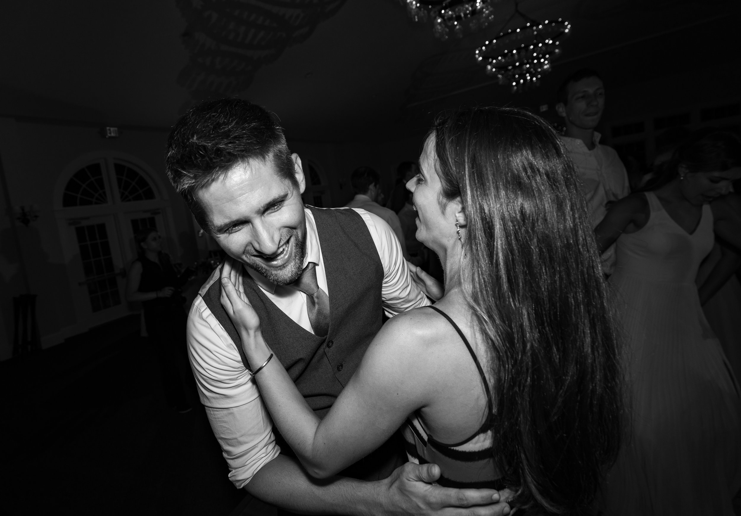 black and white photo of guests dancing during wedding reception