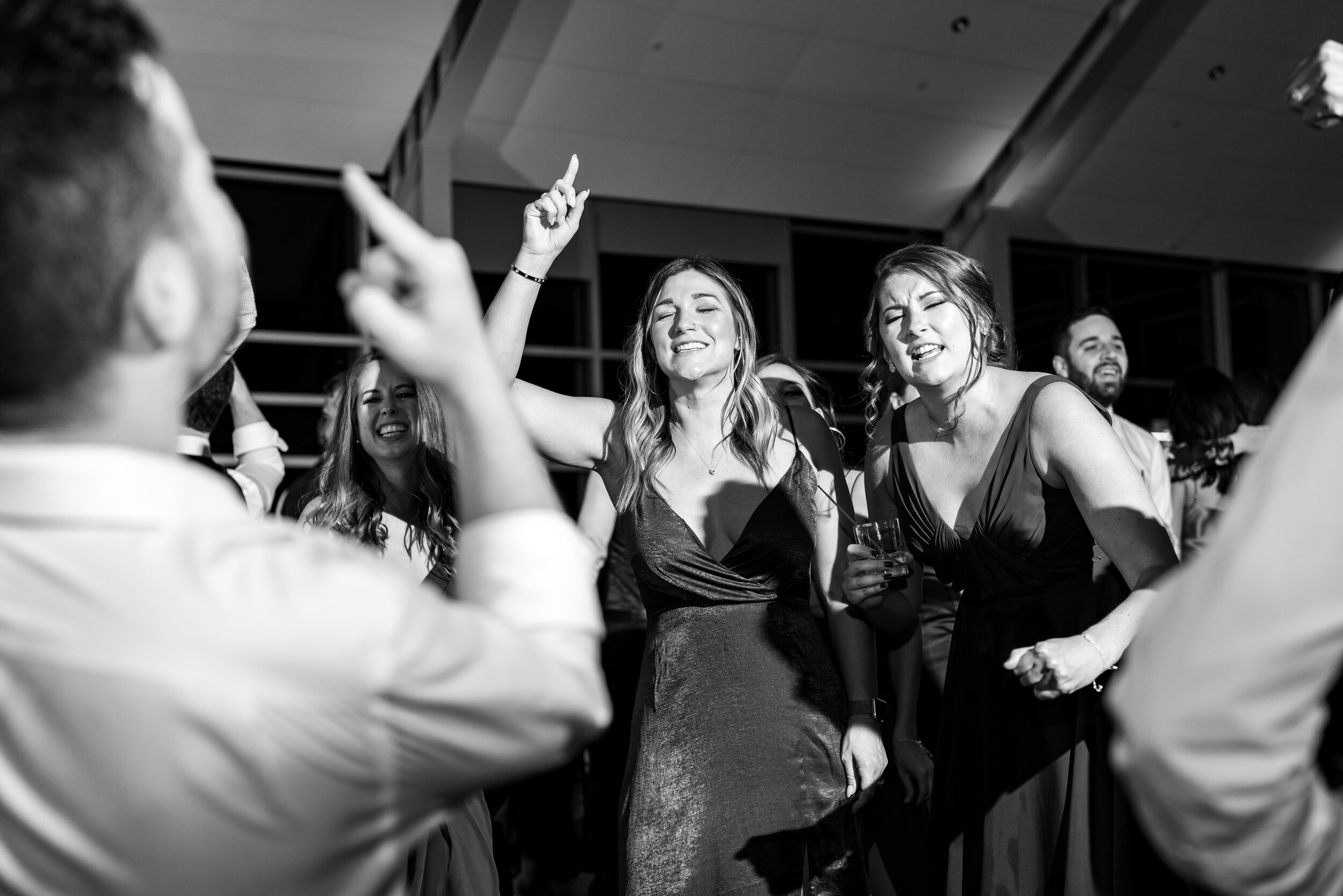 Bridesmaids and groomsmen singing and dancing on the dance floor
