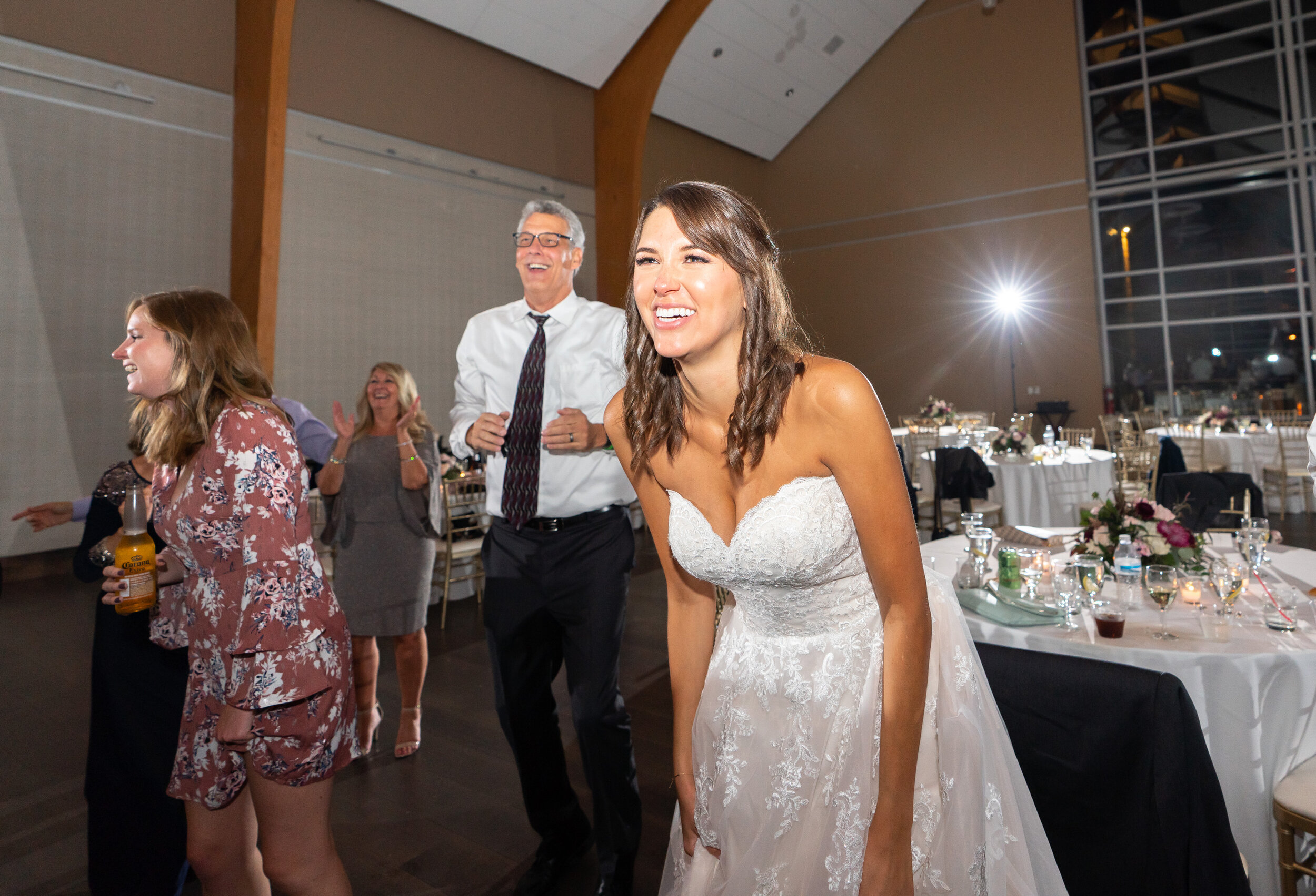 Bride watching the groom lifted in the air at Riverview Occoquan